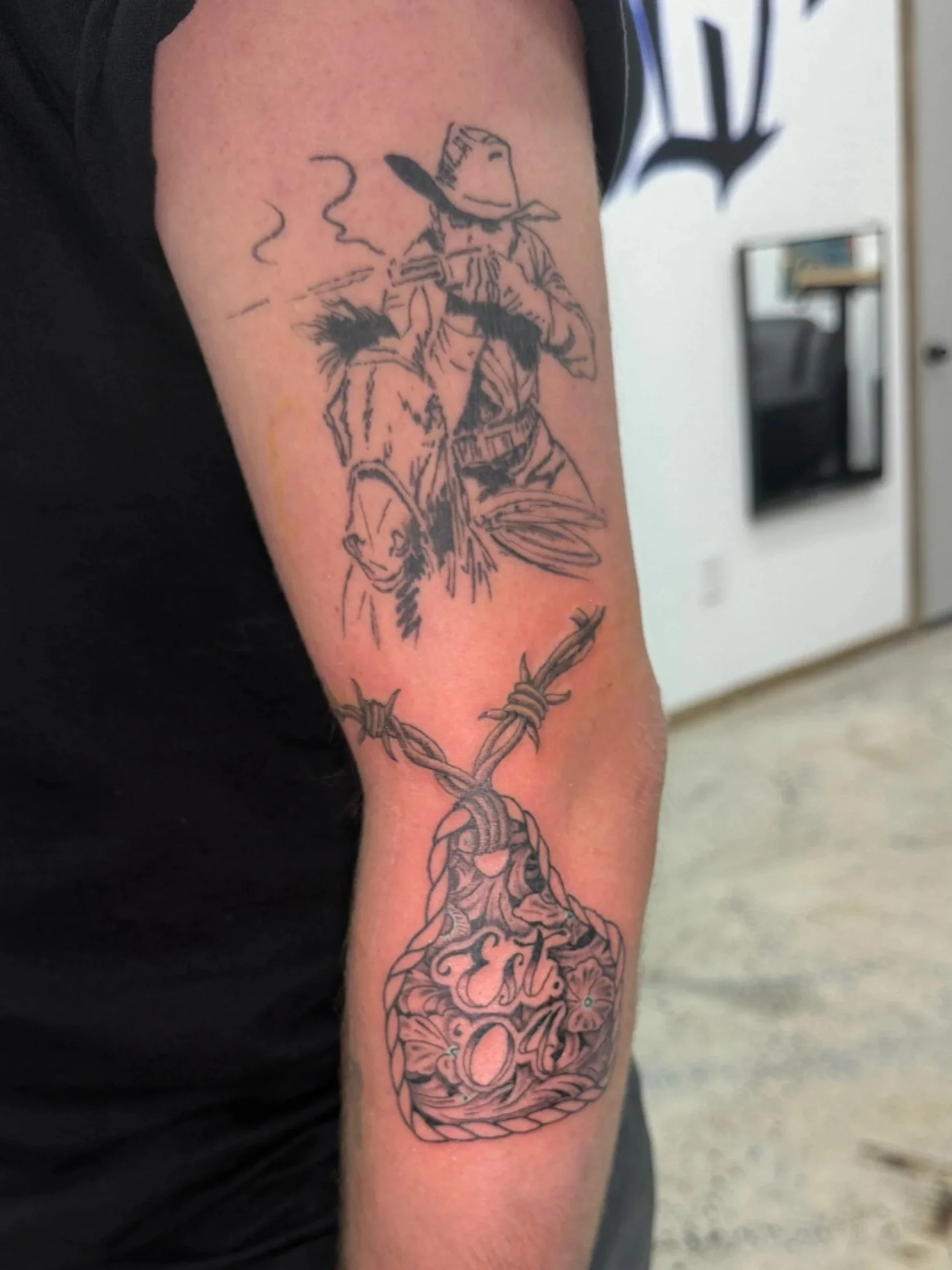 Tattoo of a firefighter with a dog, a fire helmet, a fire axe, and a fire hose with a knot.