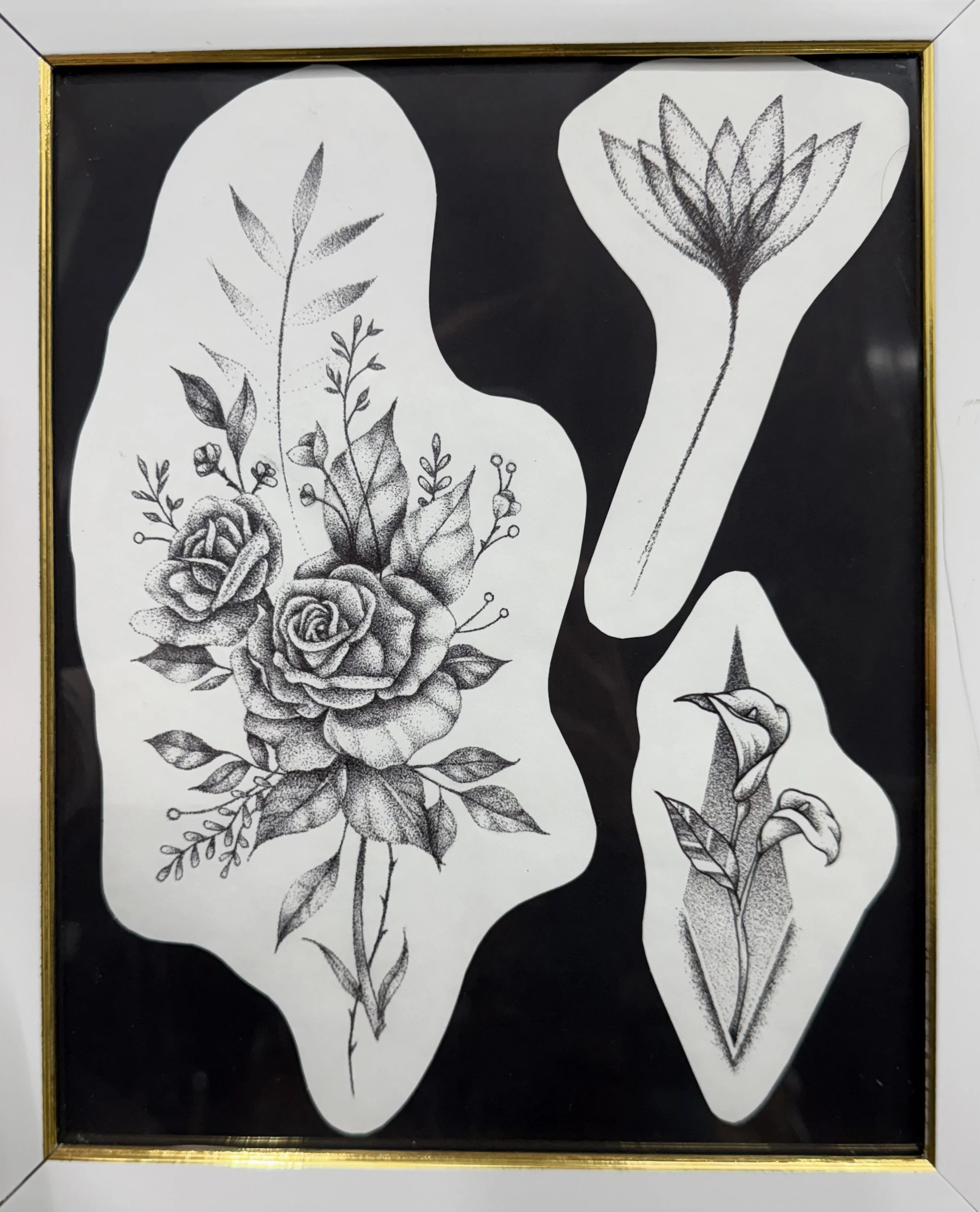 Black and white floral illustration featuring roses, tulips, and various leaves, printed on paper with irregular white shapes on a black background.