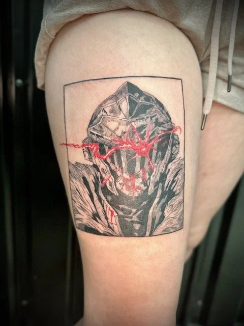 Tattoo of a masked figure with red lightning or energy lines on upper thigh