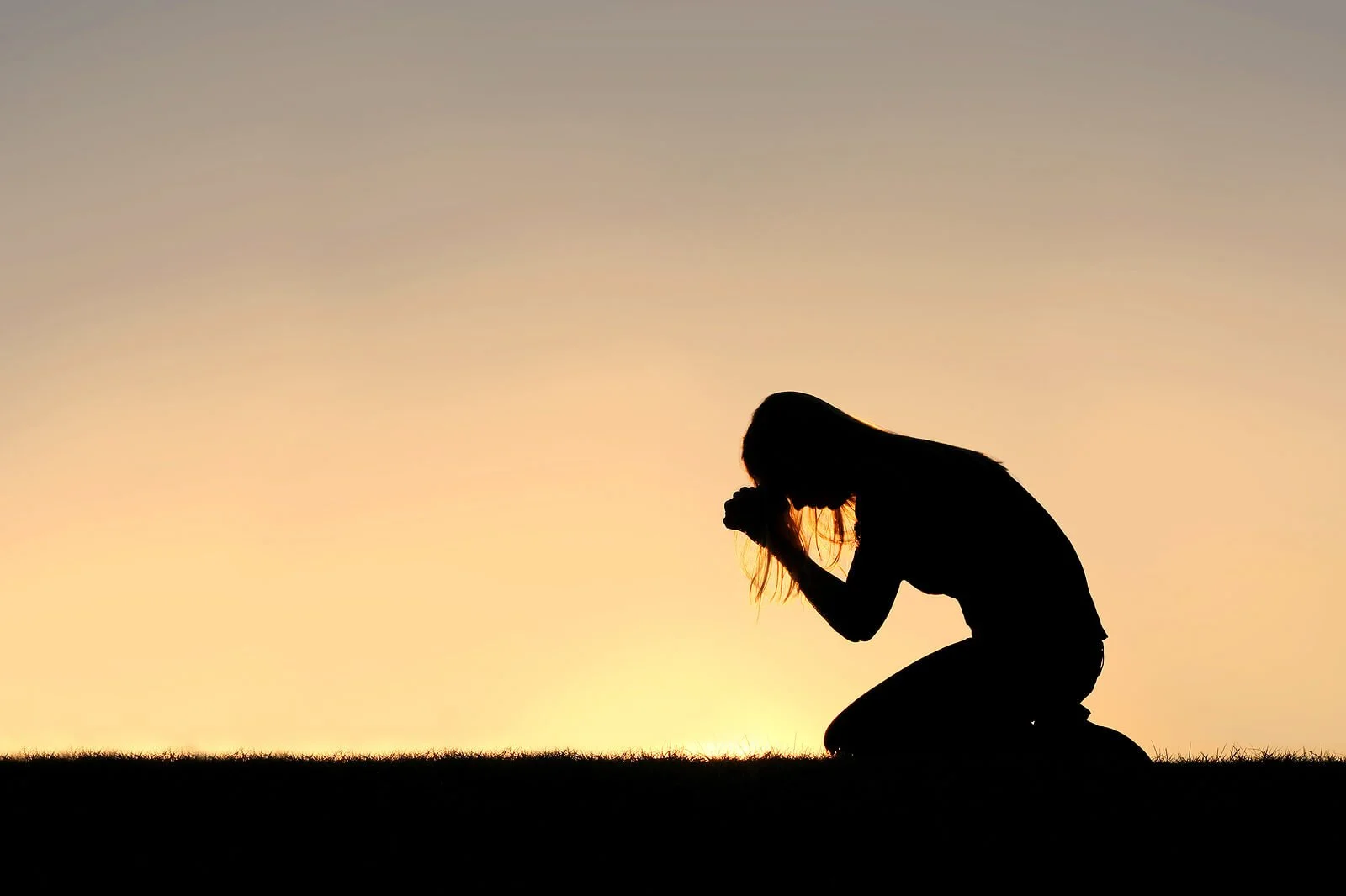 Silhouette of a woman praying in front of a lavender landscape. Do you feel the need to pray for forgiveness after ERP for OCD? Make sure your treatment is workig for you with online OCD therapy in Wauwatosa, WI.
