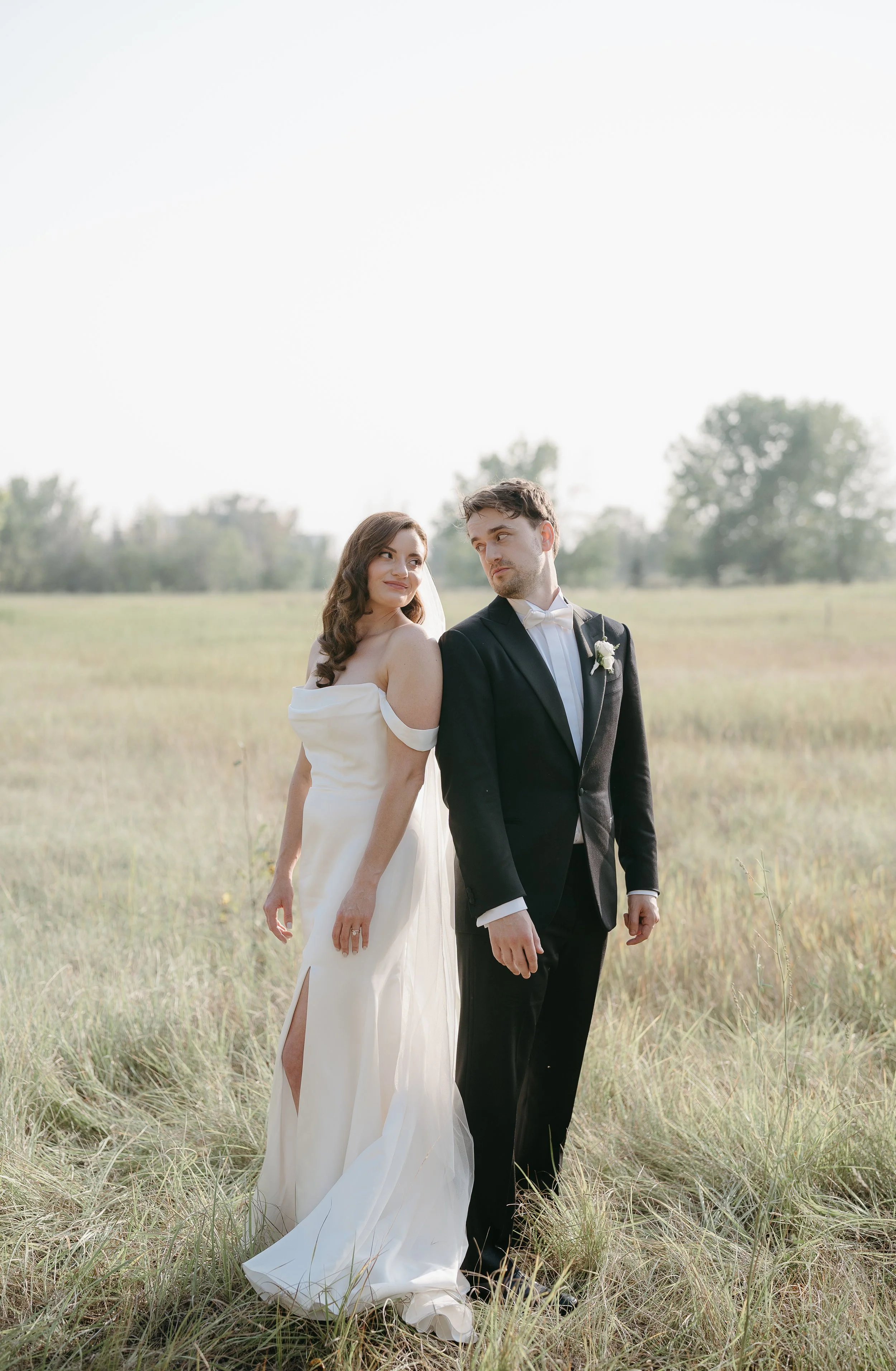 CALGARY ALBERTA WEDDING PHOTOGRAPHER.   bride and groom in field or garden in Inglewood bird sanctuary
