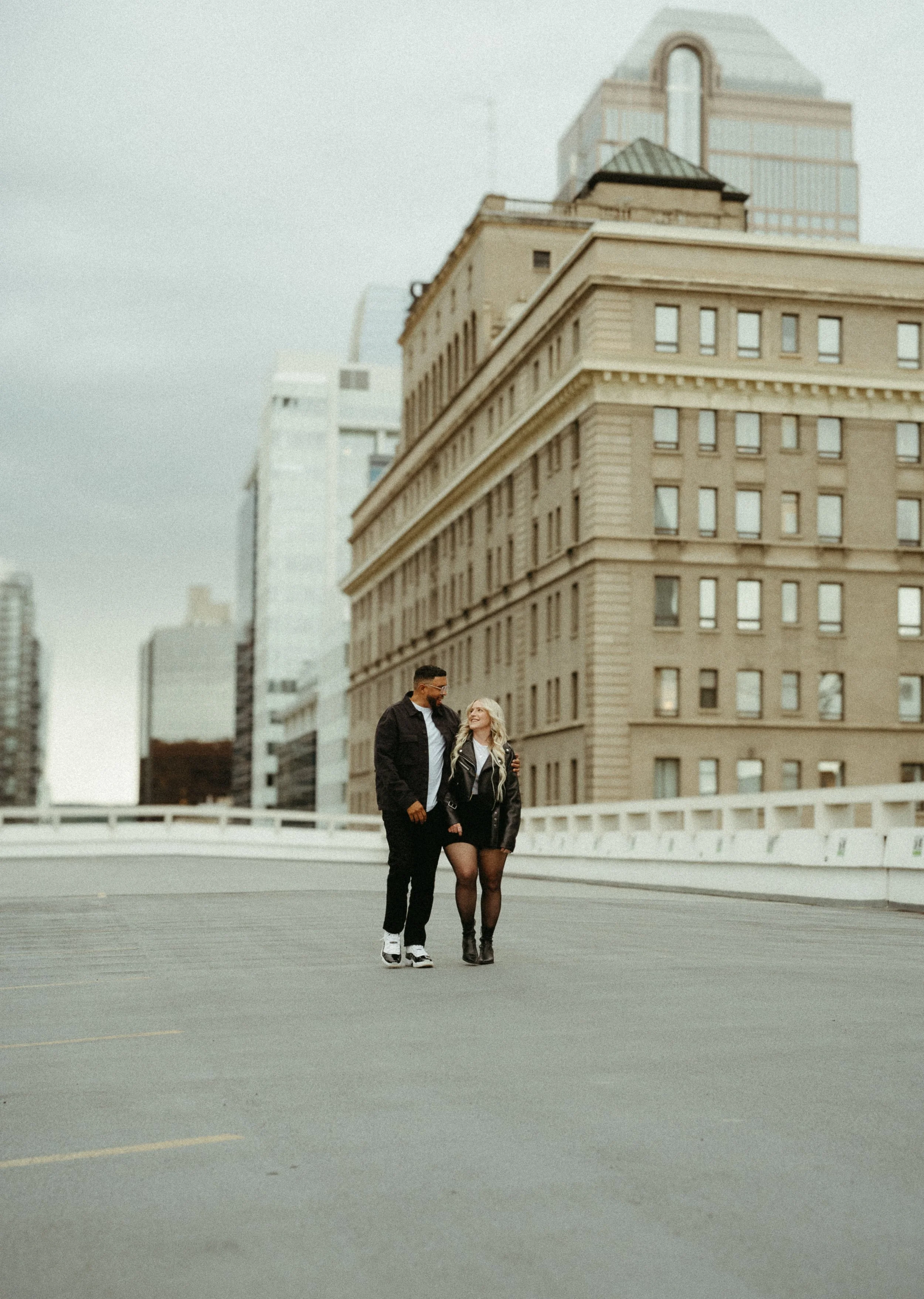 Calgary, Alberta.   Couples photo session in Downtown Calgary with the Palliser Hotel in the background, shot by KC Photography