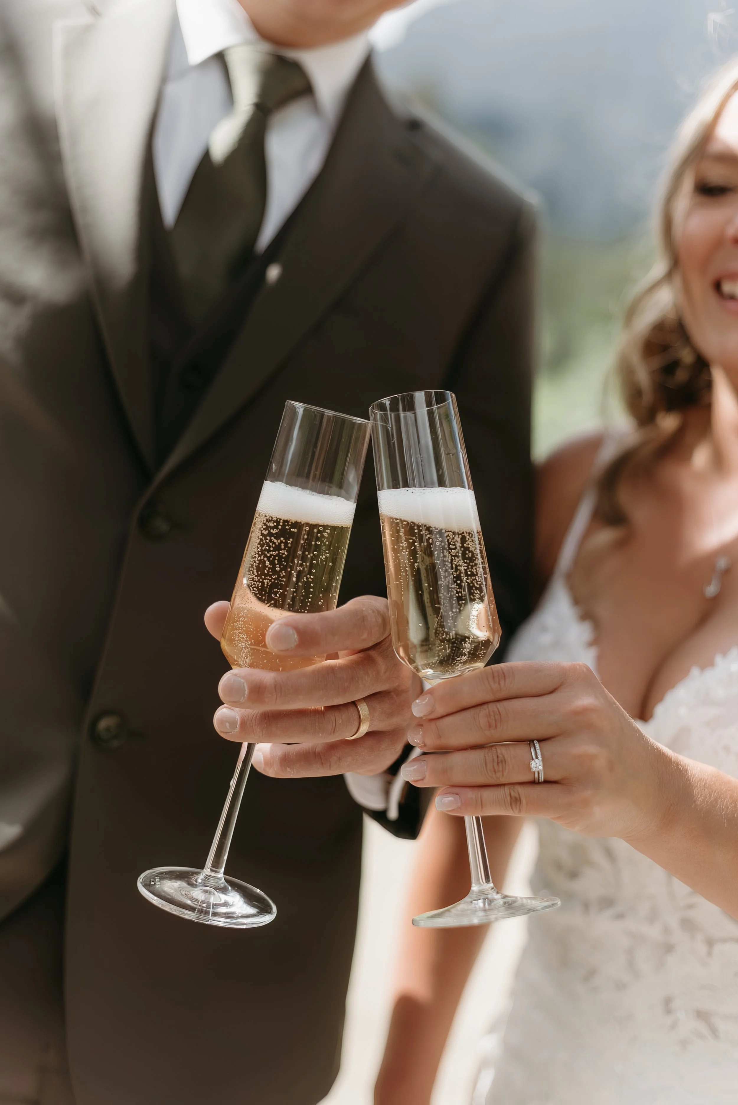 Canmore alberta wedding. bride and groom toasting with champagne at Canmore alberta wedding