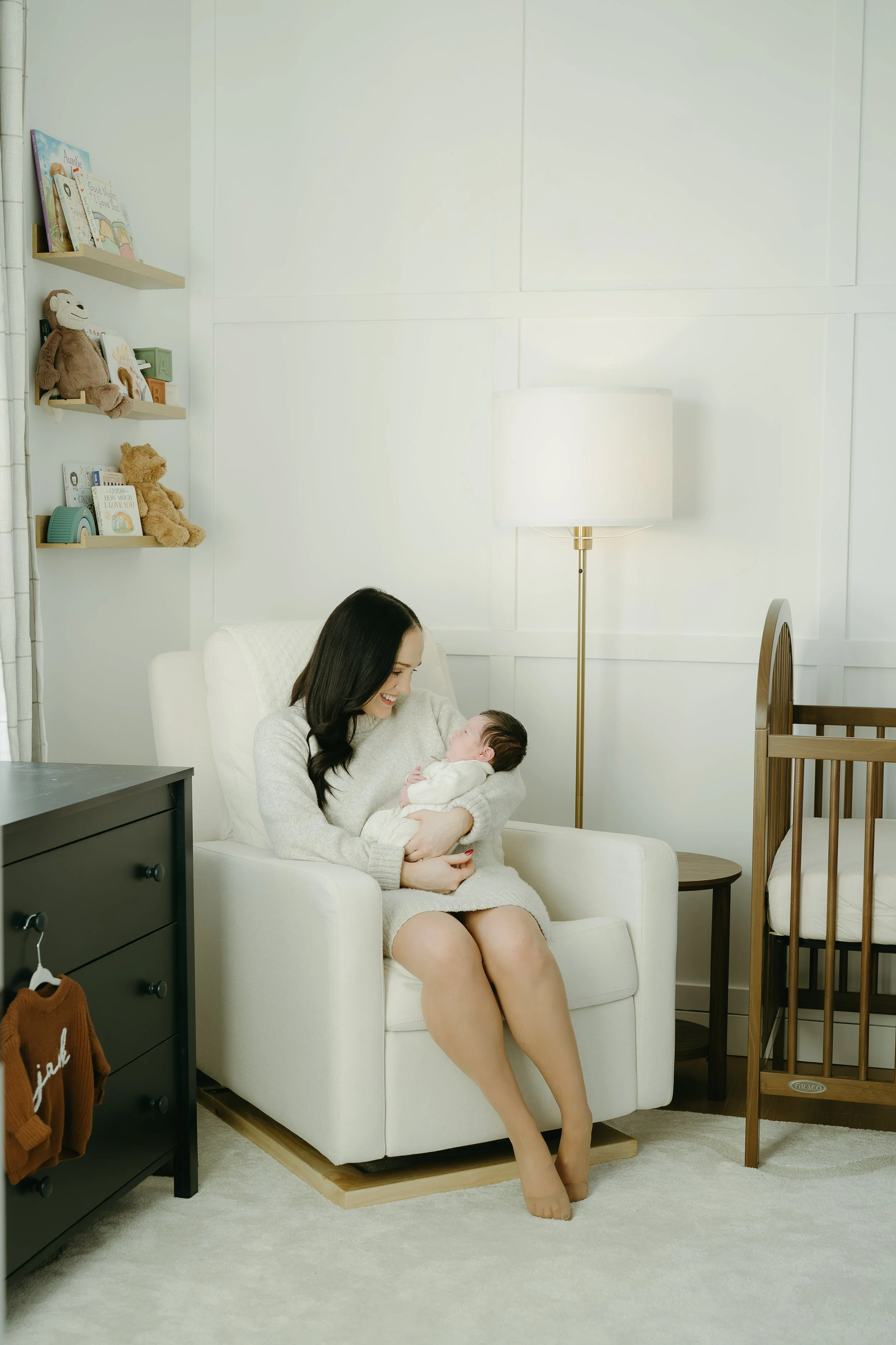 Calgary Alberta Maternity and Newborn Photographer. Mom in nursery with new baby.