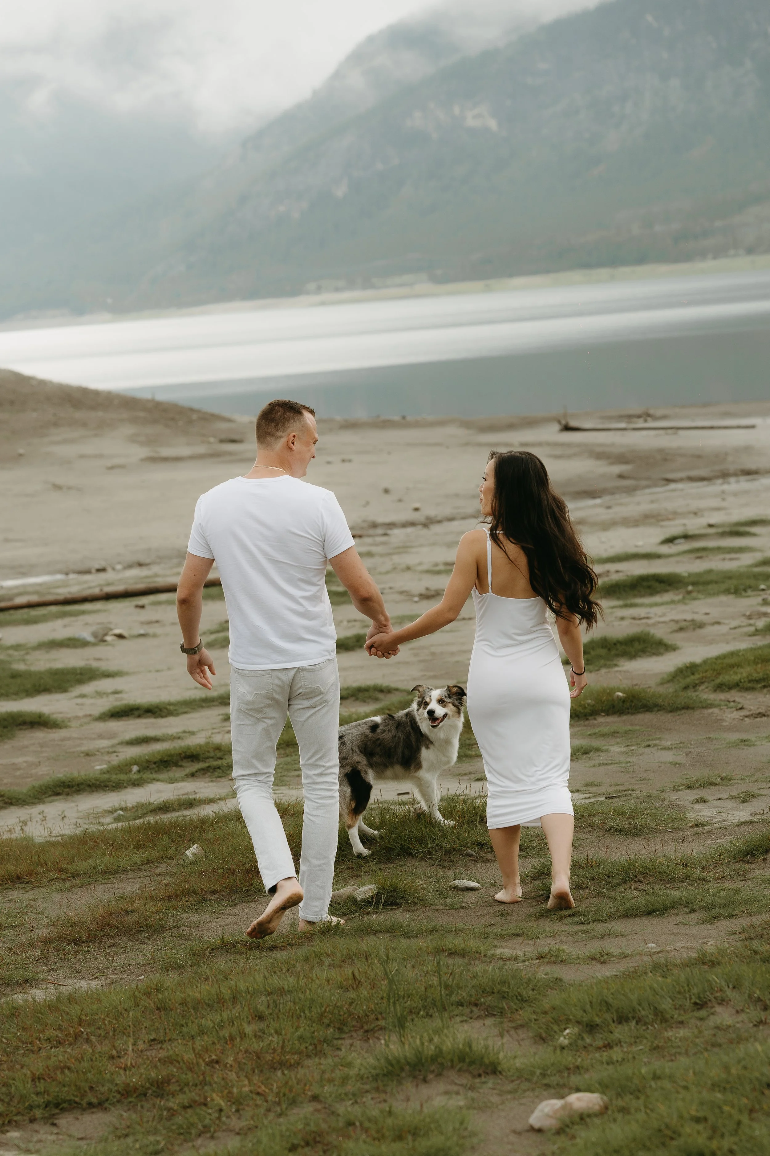 Kananaskis Wedding Photographer. Couple in white clothes in a mountain lake in Alberta near Banff, shot by KC Photography