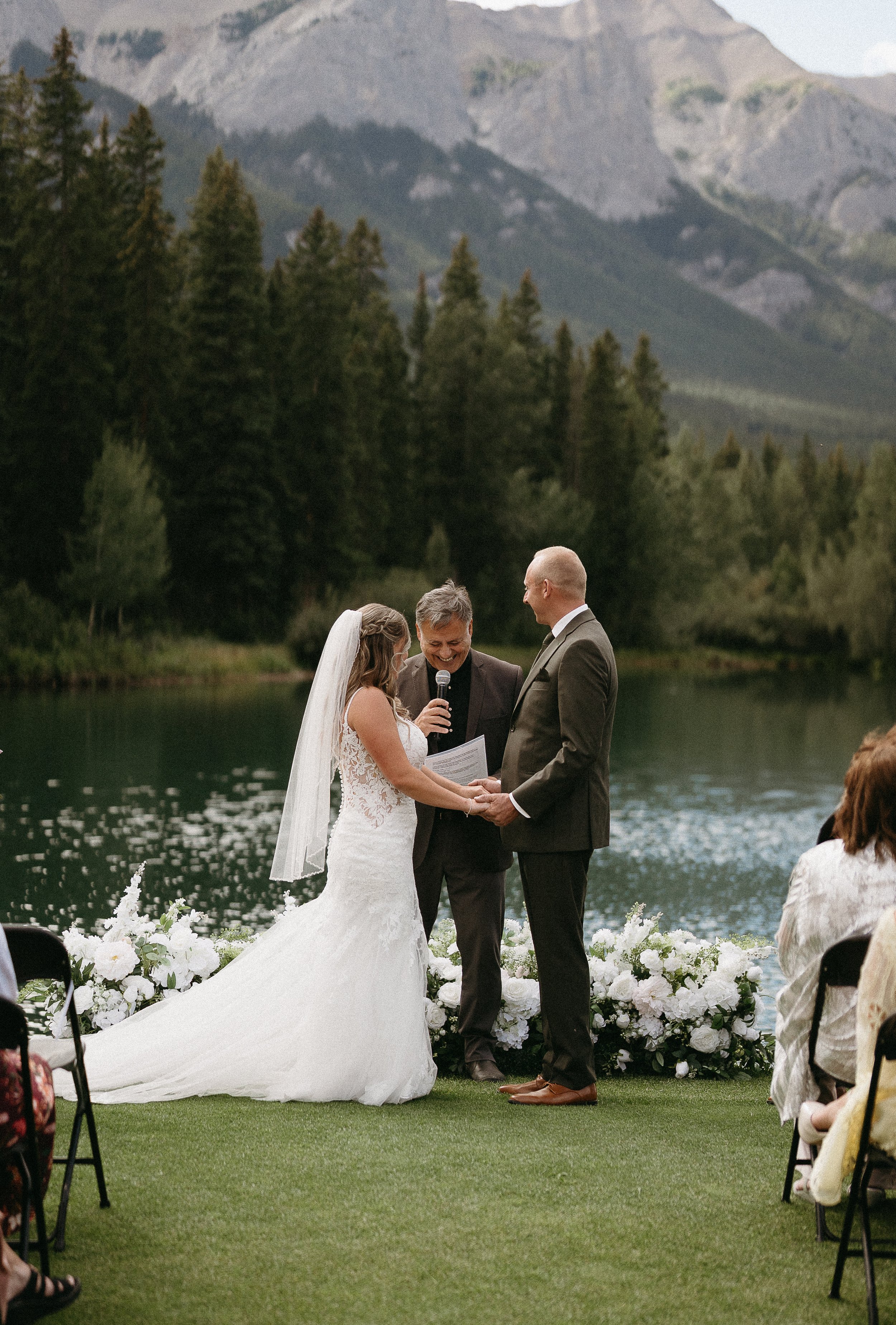 CANMORE, ALBERTA WEDDING PHOTOGRAPHER. bride and groom on the golf course in Canmore getting married by officiant
