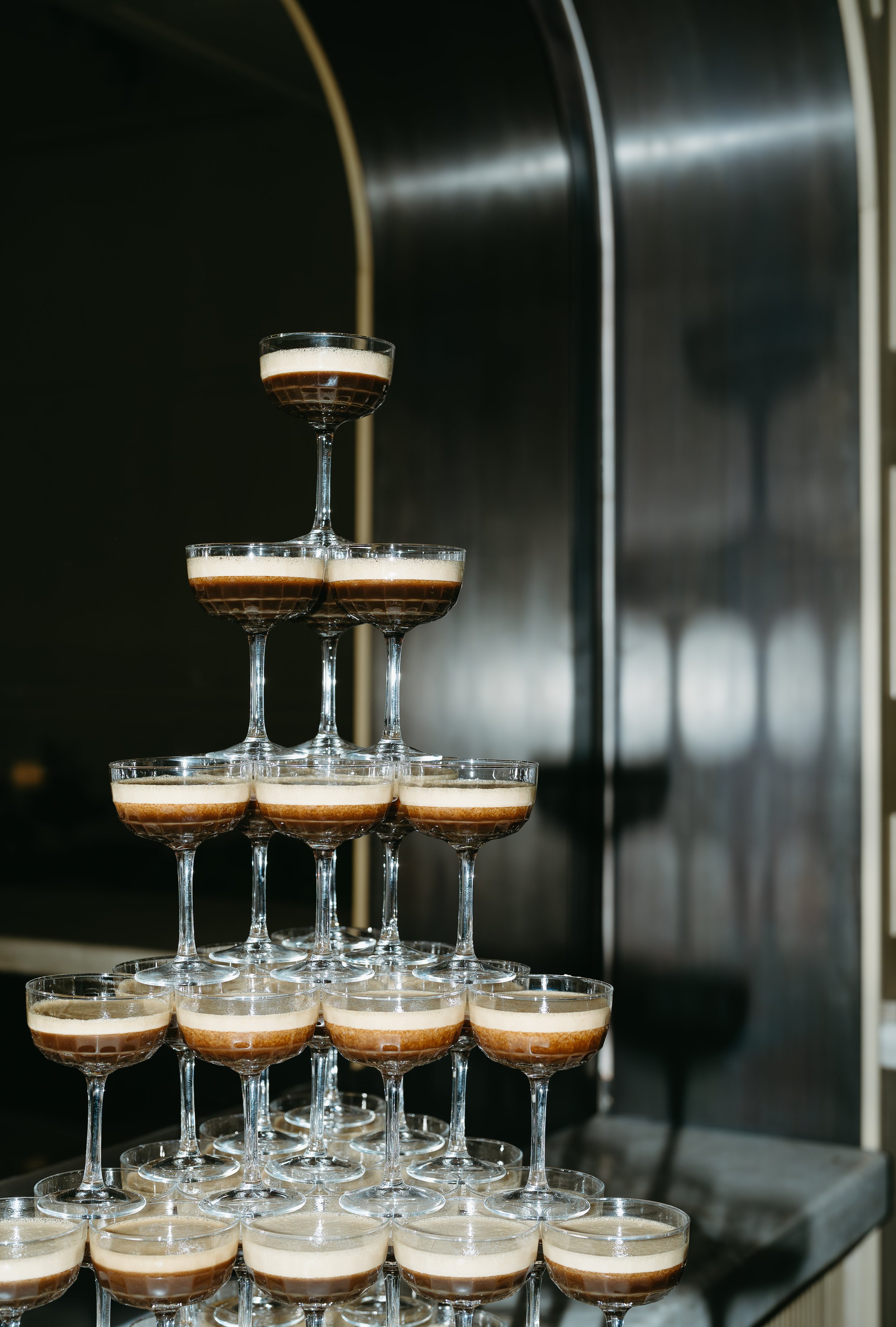A champagne glass tower of espresso martini's. July 2025 Calgary Elopement/Wedding Editorial Session with KC Photography