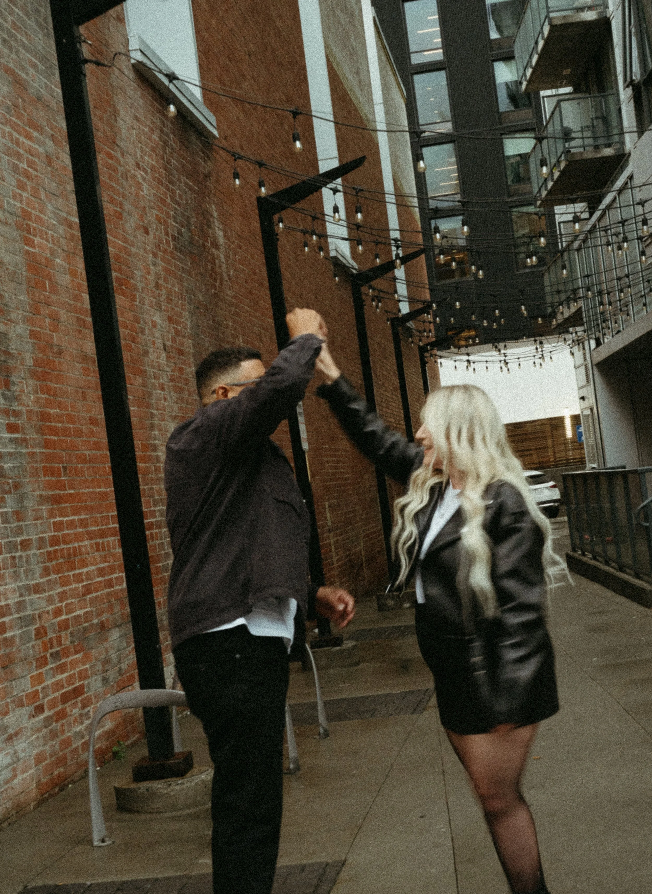 Calgary, Alberta.   Couples photo session in Downtown Calgary with the Palliser Hotel in the background, shot by KC Photography