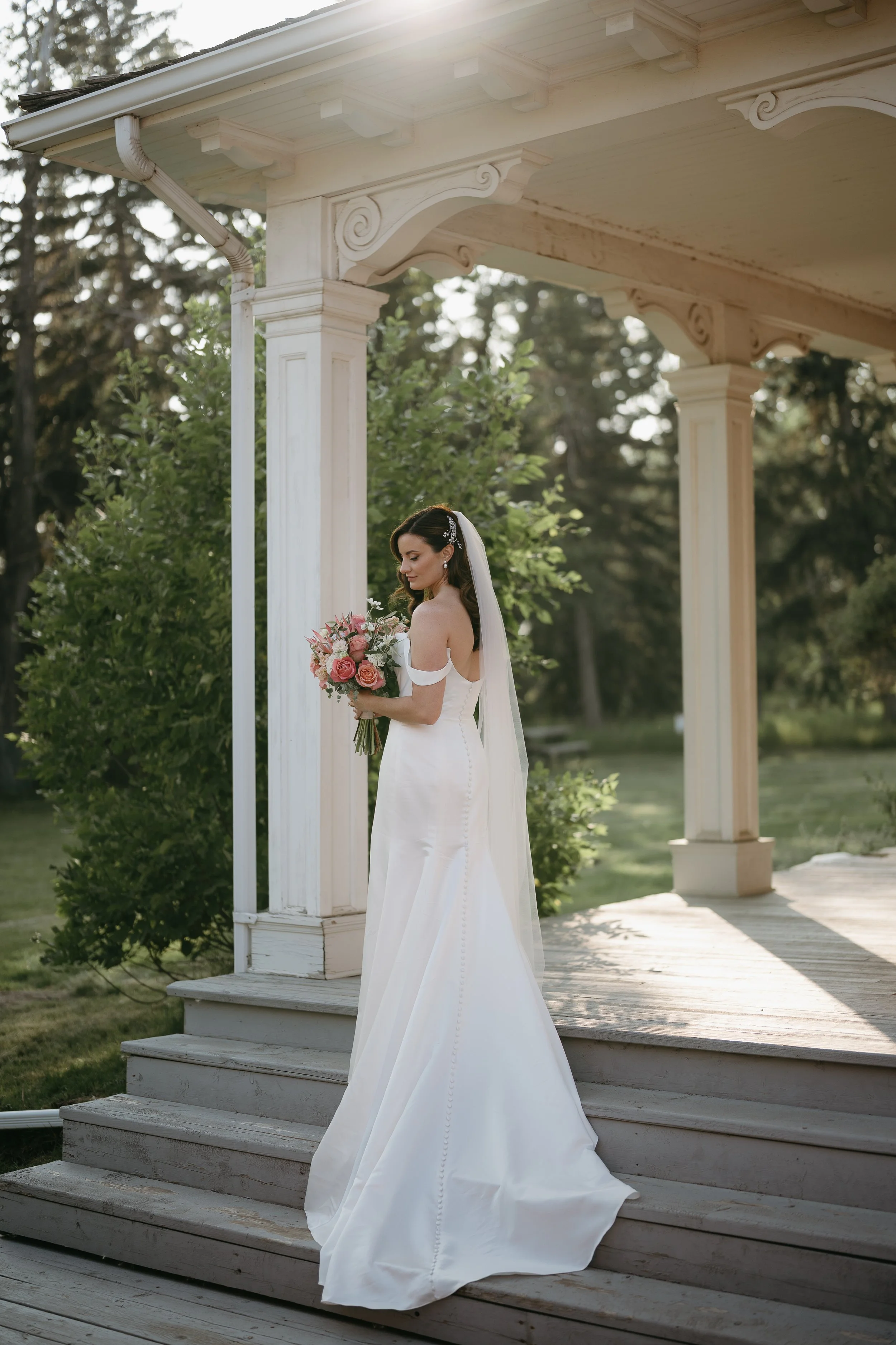 calgary, alberta wedding photographer.   bride standing at the Deane house stairs for her bridal portrait