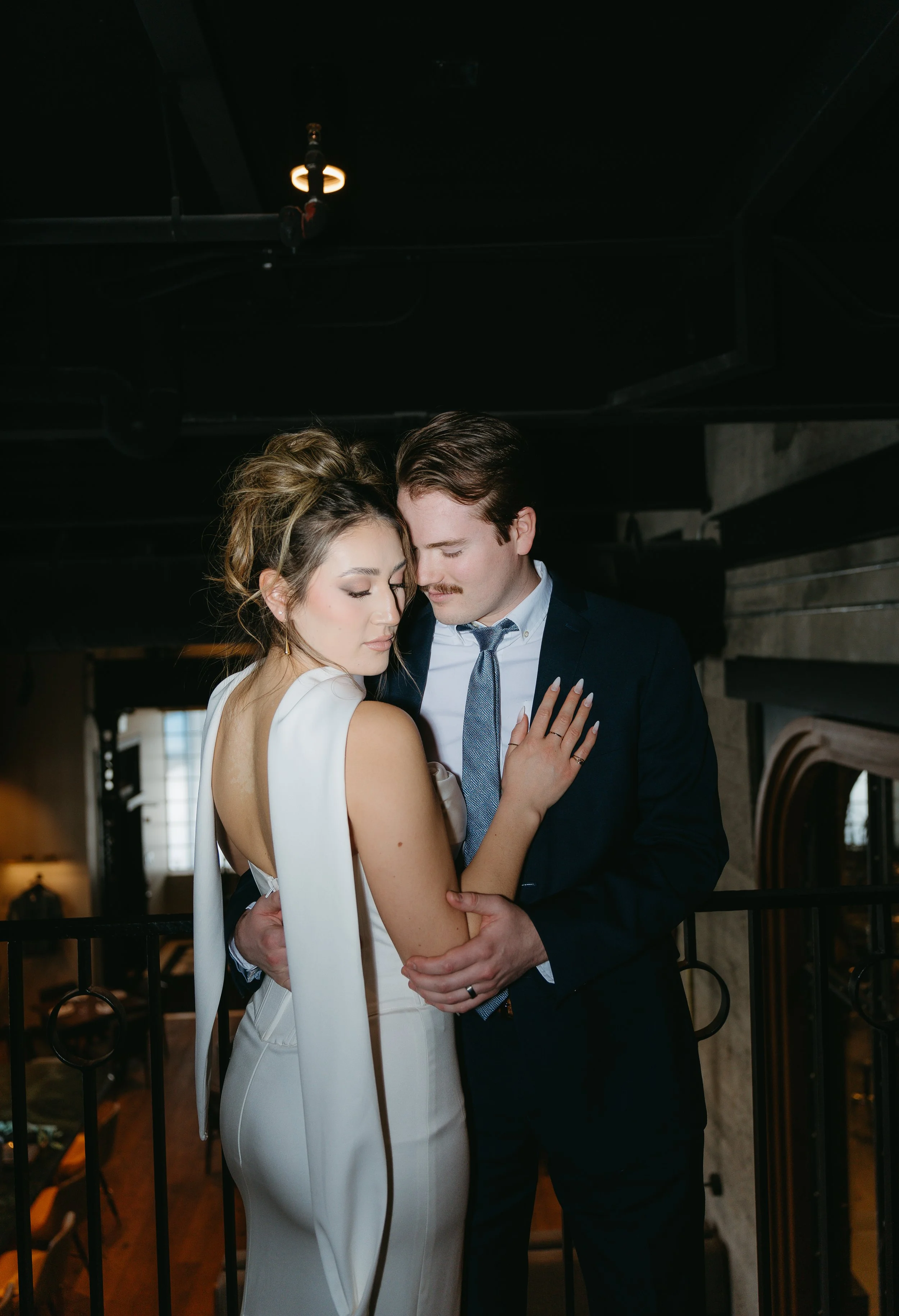 A groom holds his bride. Calgary Elopement/Wedding Session with KC Photography