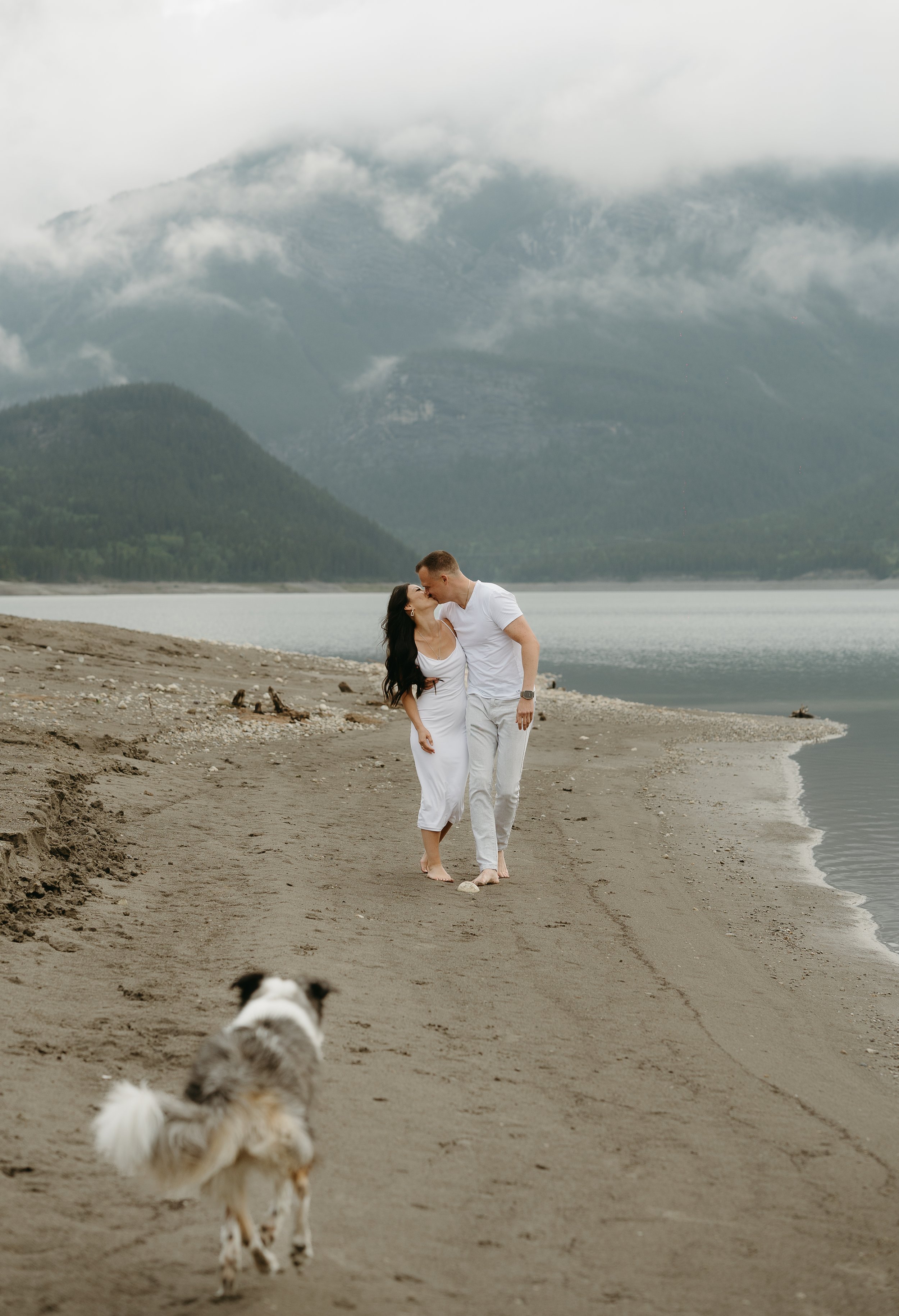 Kananaskis Wedding Photographer. Couple in white clothes in a mountain lake in Alberta near Banff, shot by KC Photography