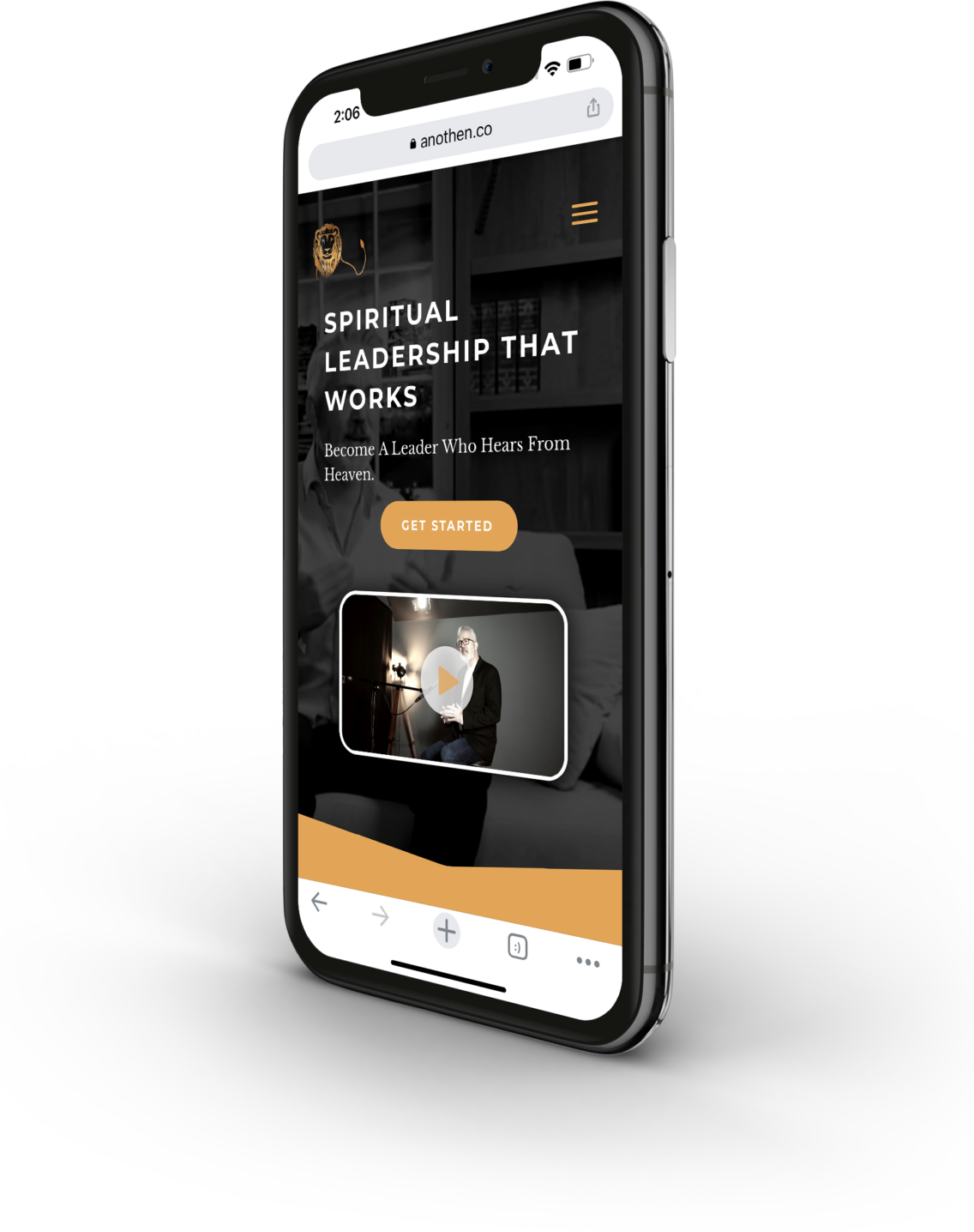 iPhone showing a website with the text 'Spiritual Leadership That Works' and an image of a man with glasses sitting in a dimly lit room with a video play button.