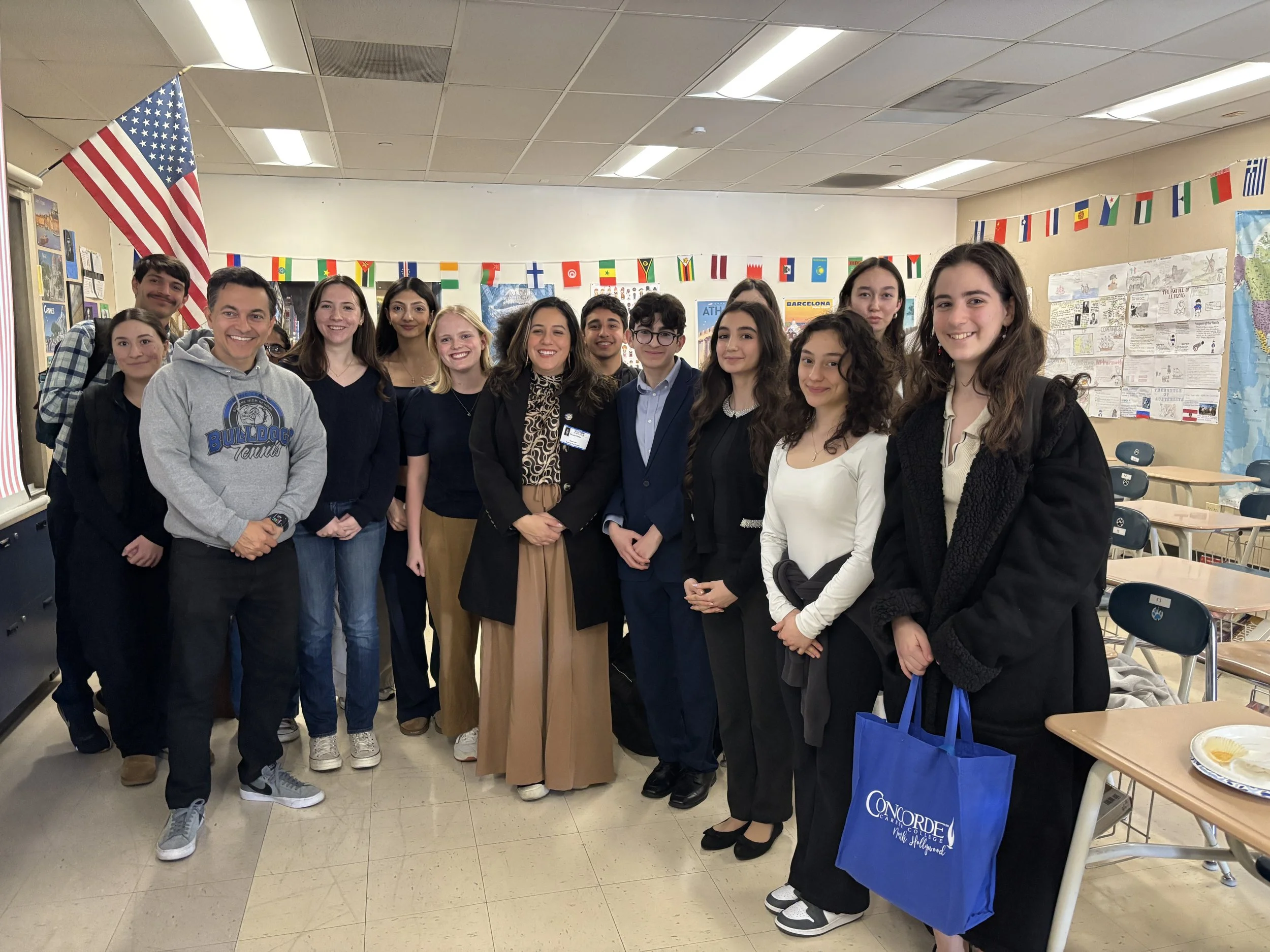 Members, students, teachers, and the Mayor posing for a photo.