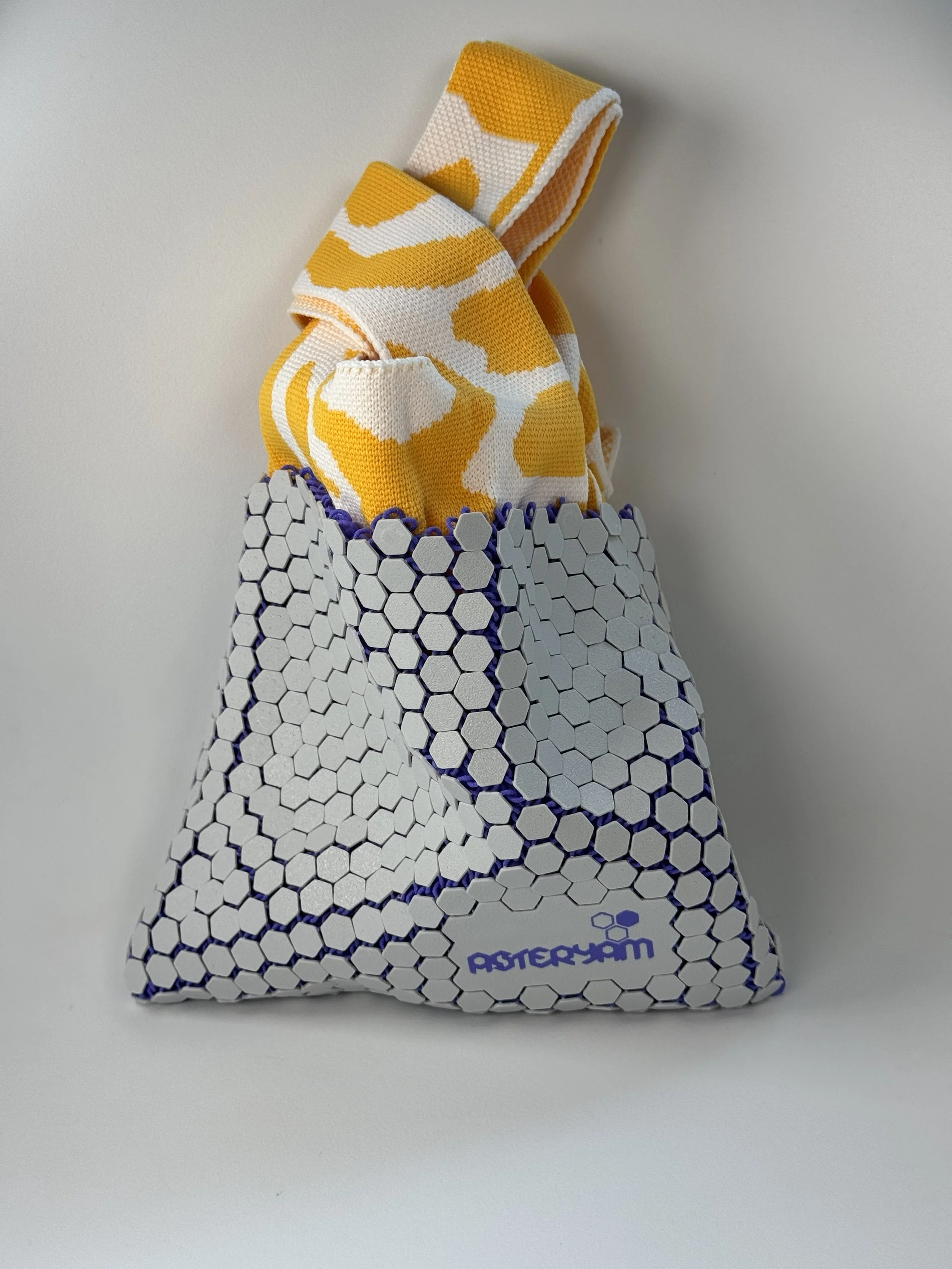 Front view of Hexa Sling bag, highlighting the 3D printed light grey hexagonal mesh with purple inner depth.