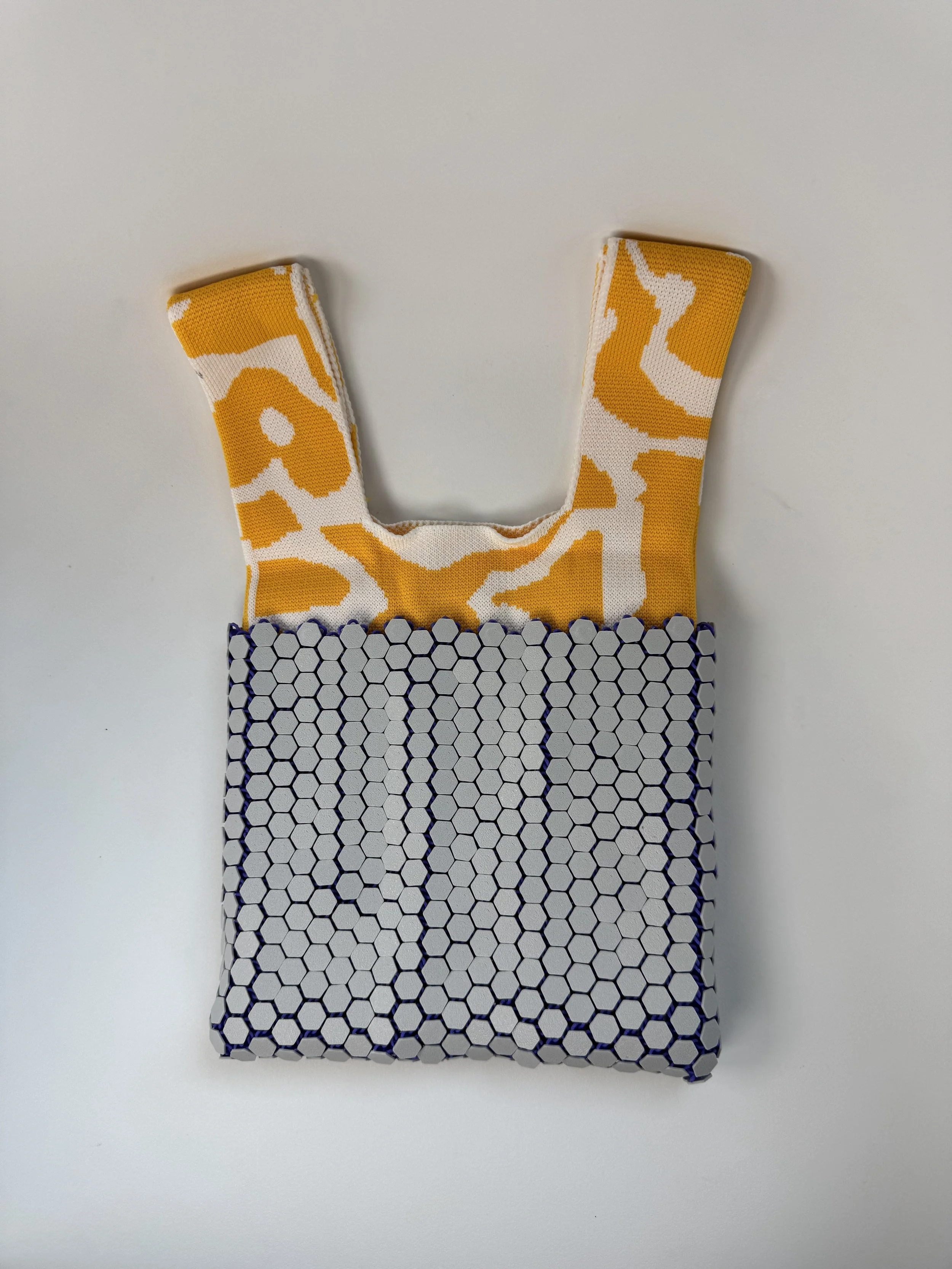 Back view showing the continuous flow of the 3D printed geometric mesh pattern.