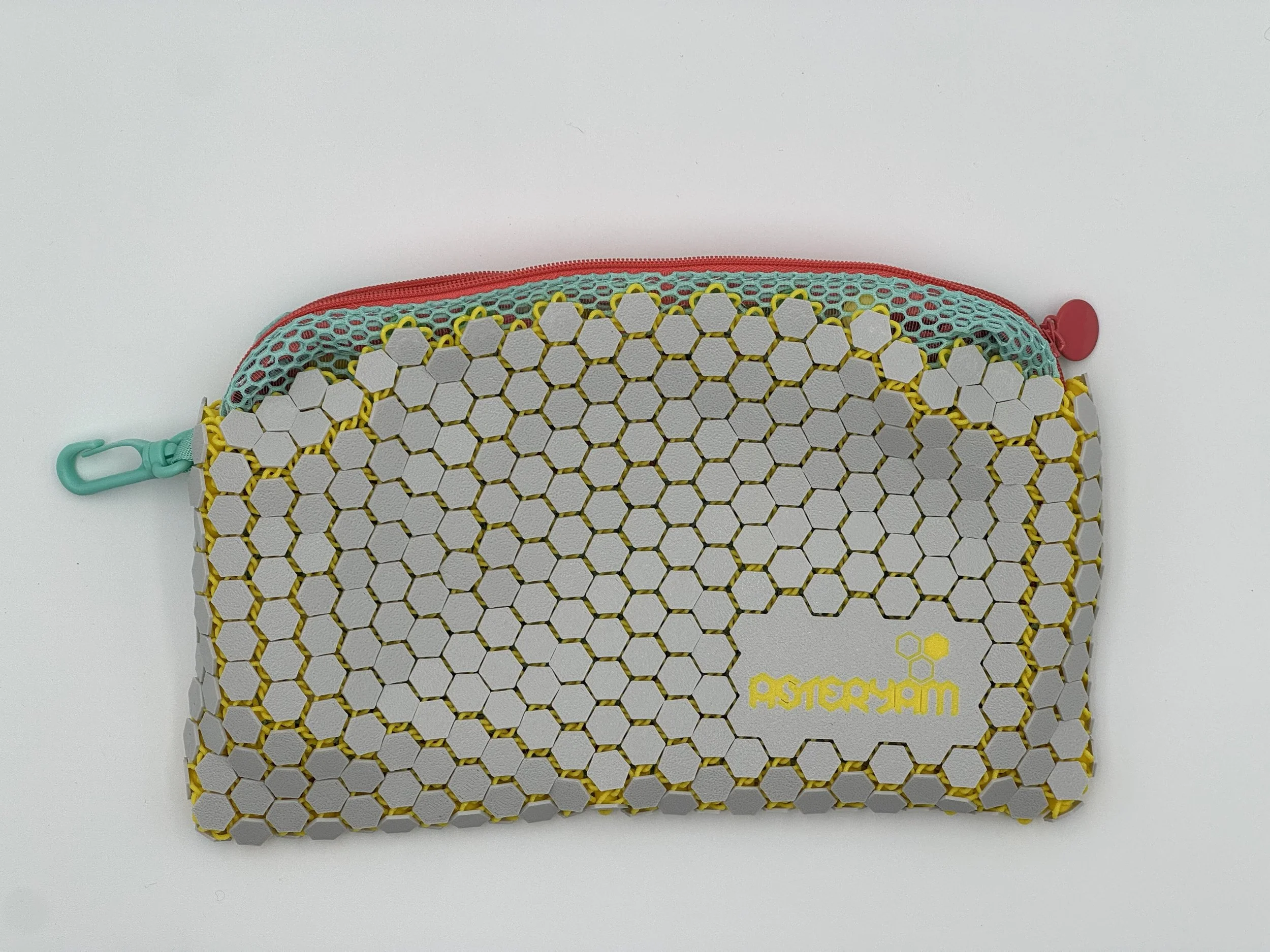 Front view of the ASTERYAM HexaFlux bag showing the continuous, flexible 3D printed chainmail texture in light grey with the logo.