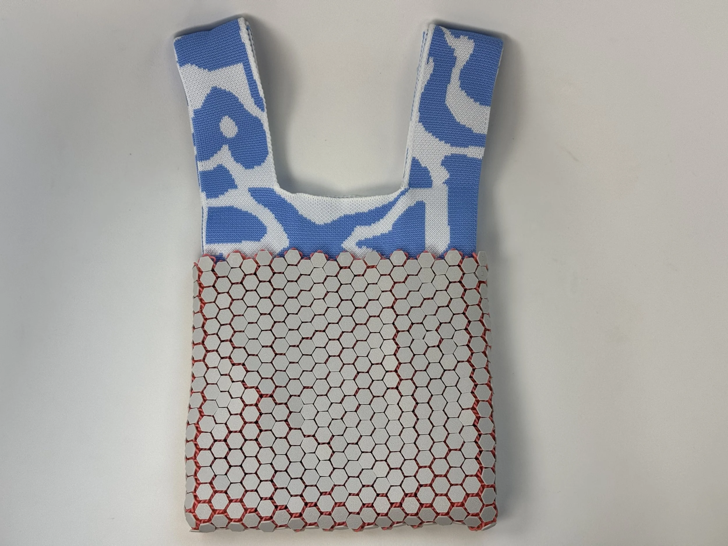 Minimalist portrait of the Hexa Sling 3D printed bag against a white background.