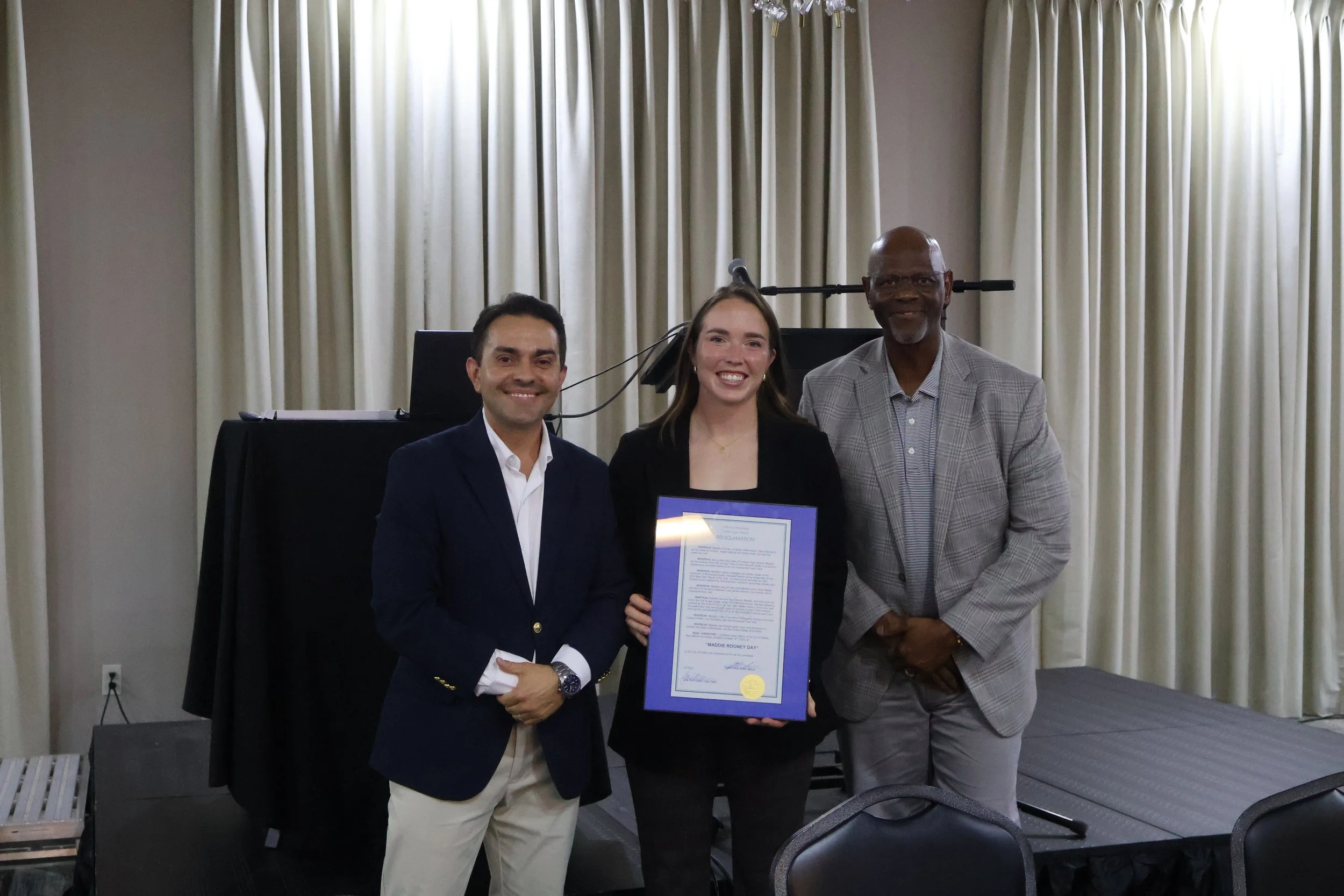 Mayor Jonathan Sena, Maddie, City Commissioner Larron Fields, with the Maddie Rooney Day proclamation