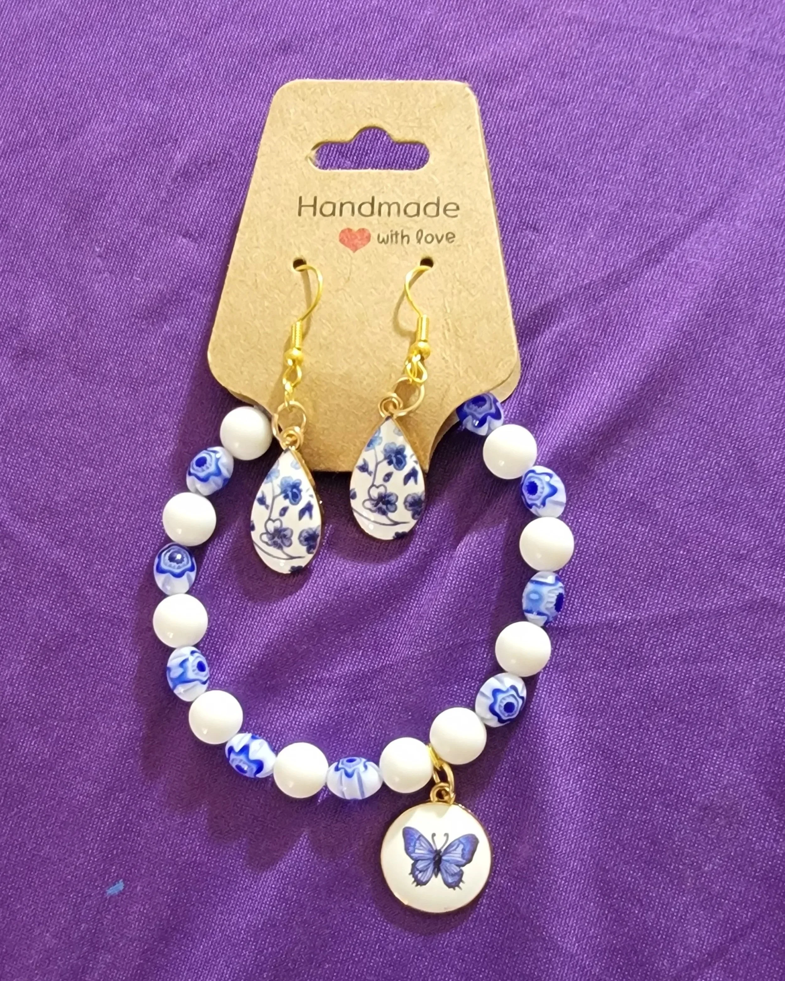 White and Blue Glass Beaded with Flower Design and Blue Butterfly Charm