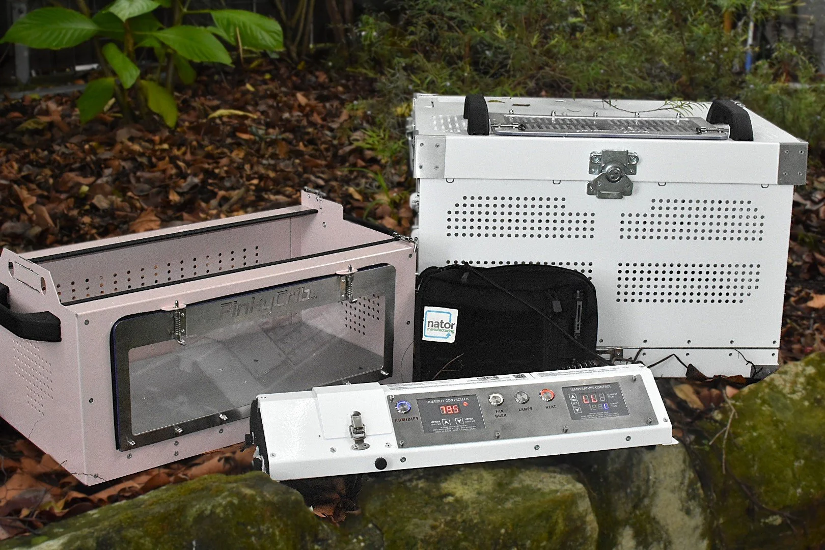 A humidity crib device outdoors on grass, with knobs and digital displays for humidity and temperature settings.