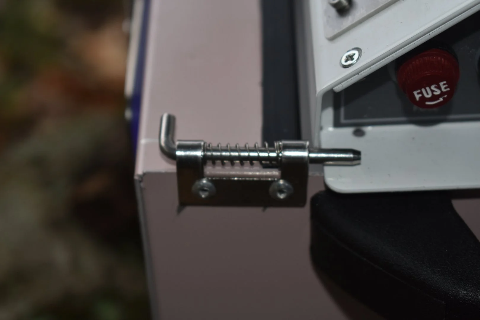 Close-up of a spring loaded latch attached to a metal intensive care unit 