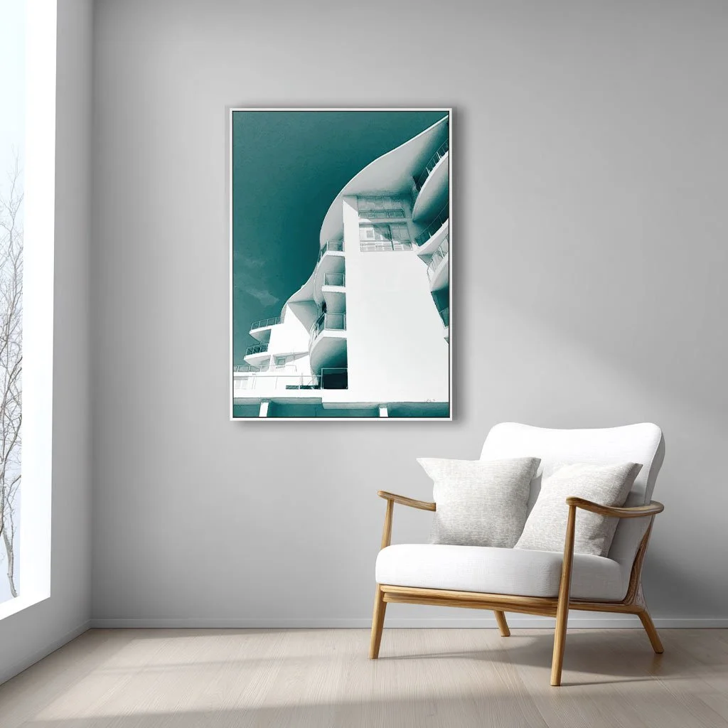 Graphic poster style wall art print of a white hotel against a teal sky. It's called Poolside.