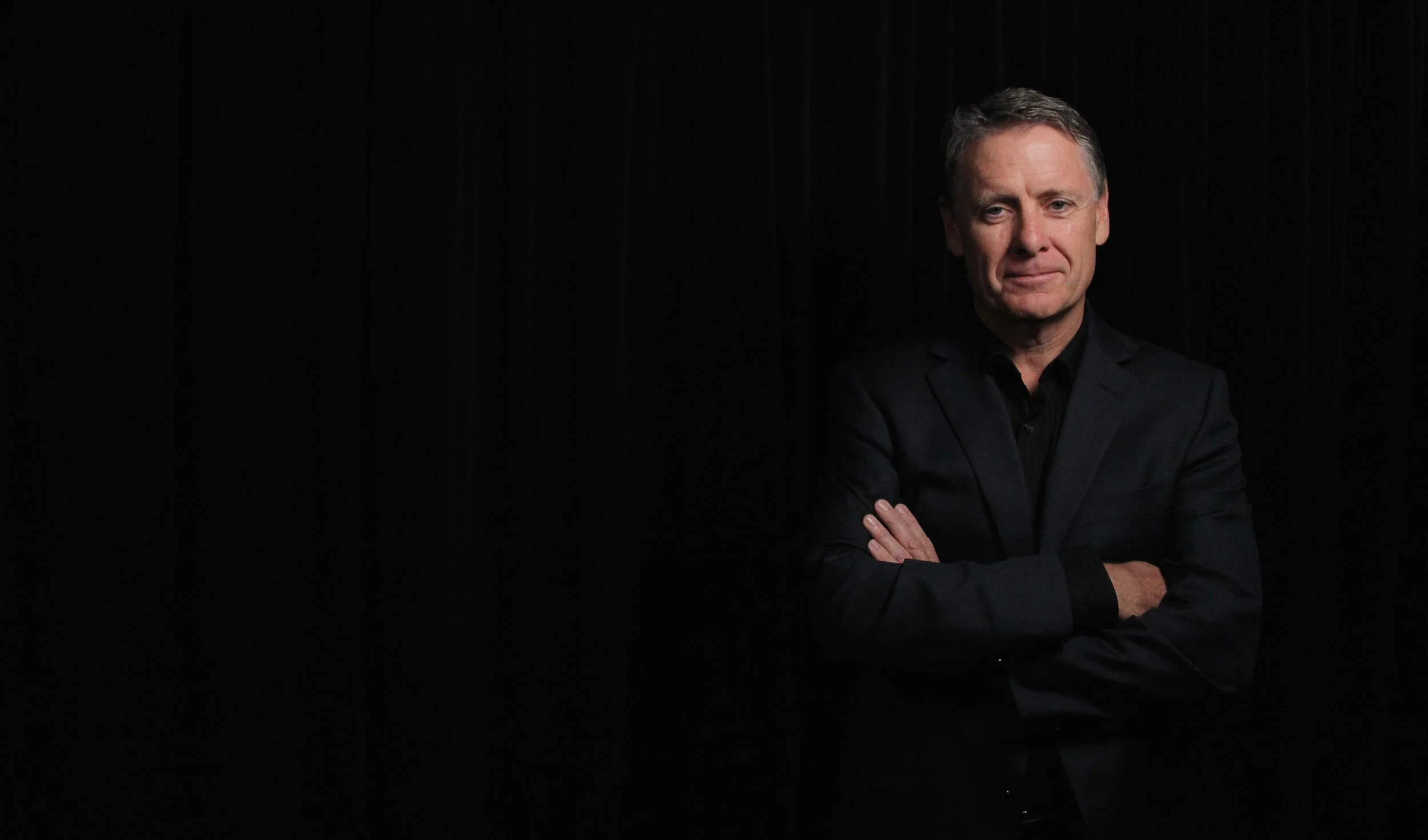 Tony Hughes black background wide friendly offset right.jpeg