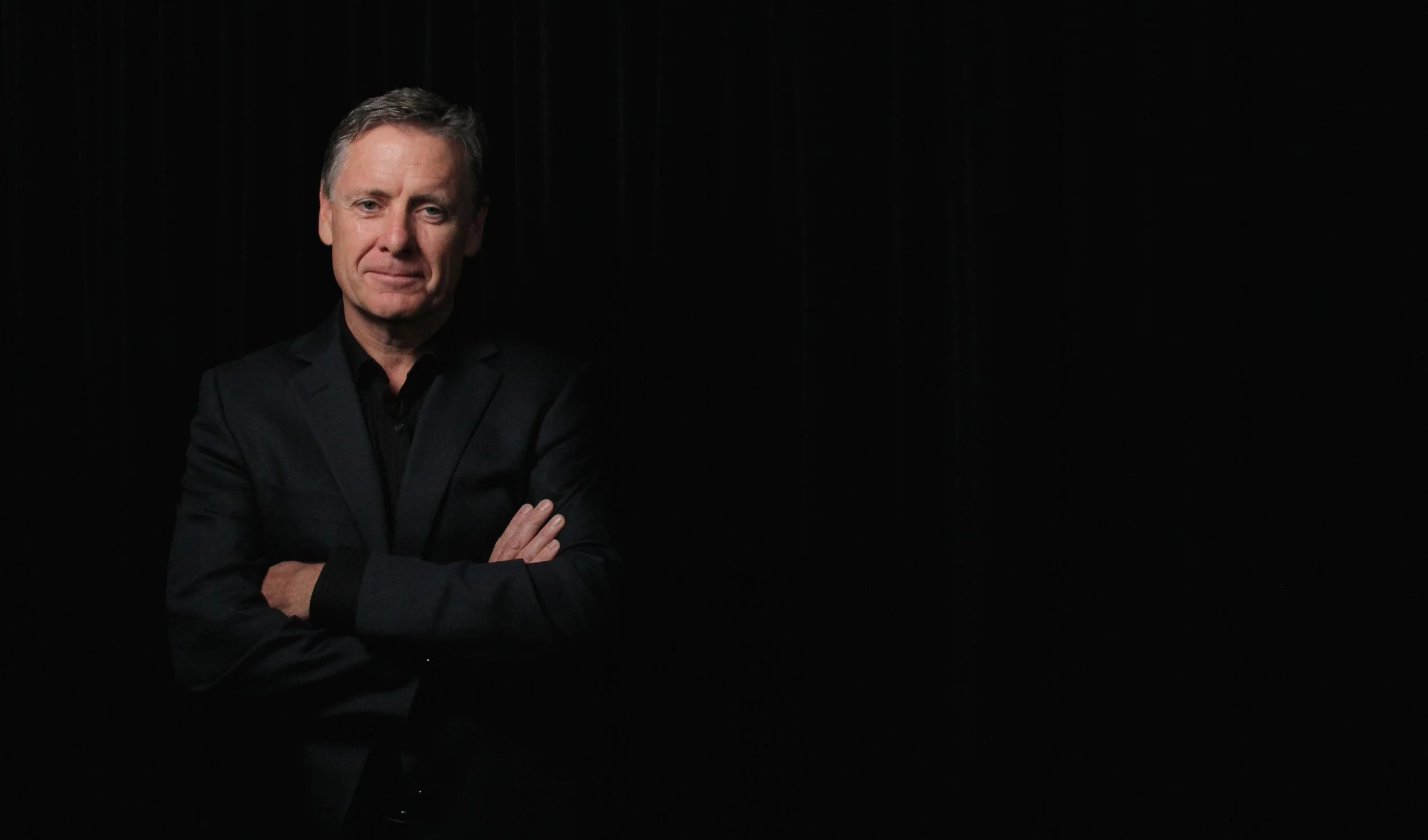 Tony Hughes black background wide friendly offset left.jpeg