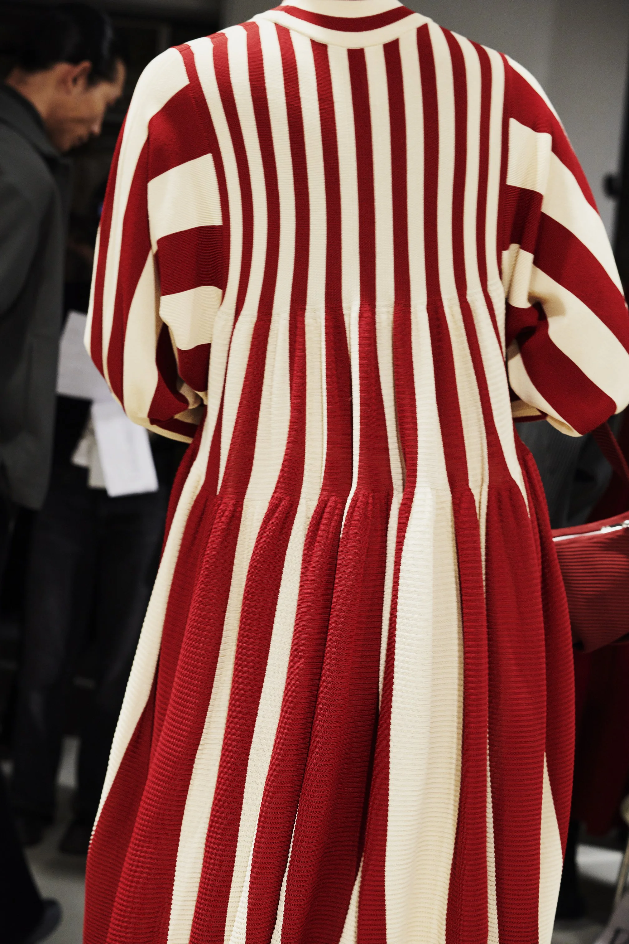 Red and white vertically striped pleated dress