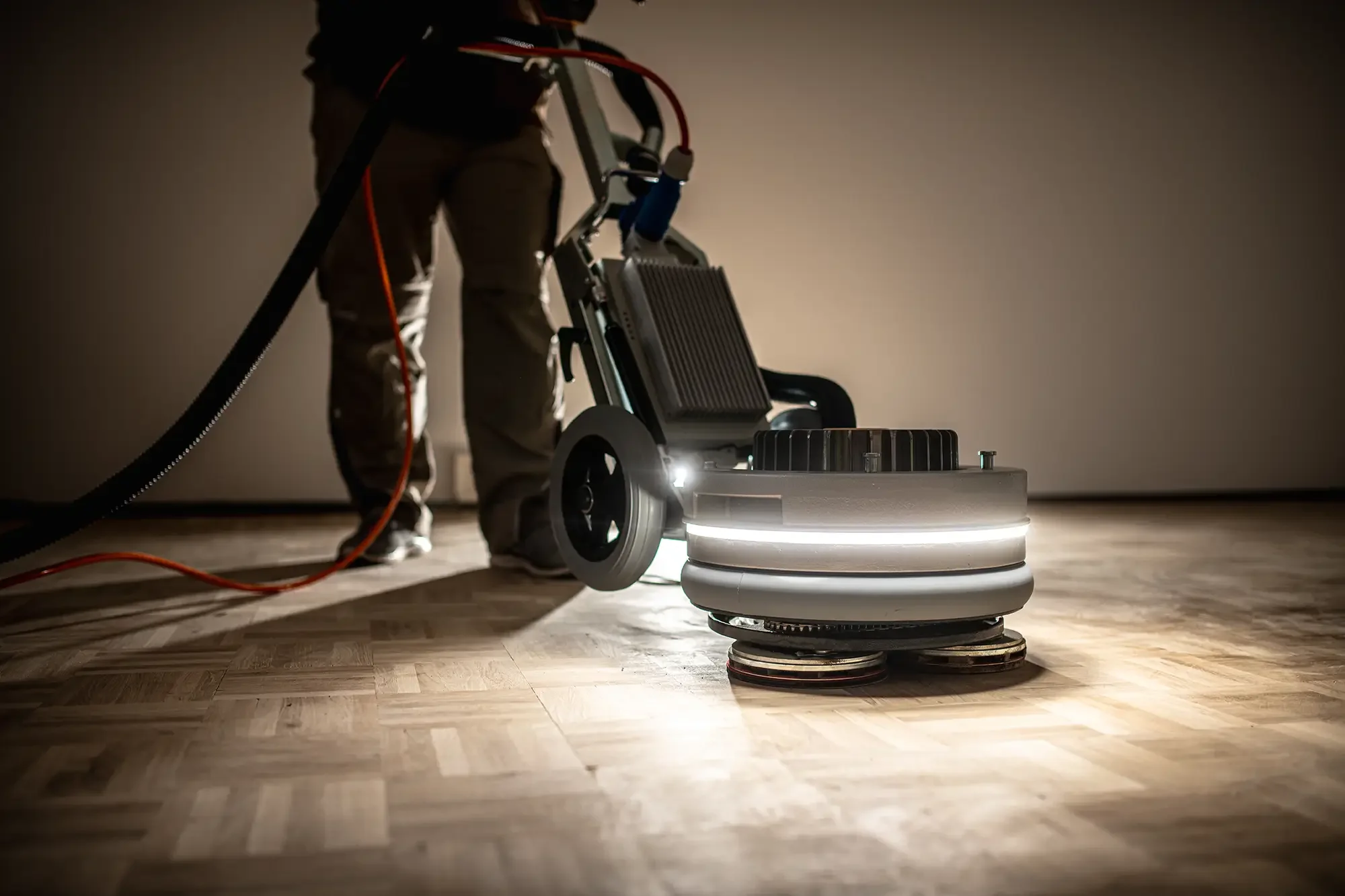 Wood floor restoration specialist sanding hardwood flooring