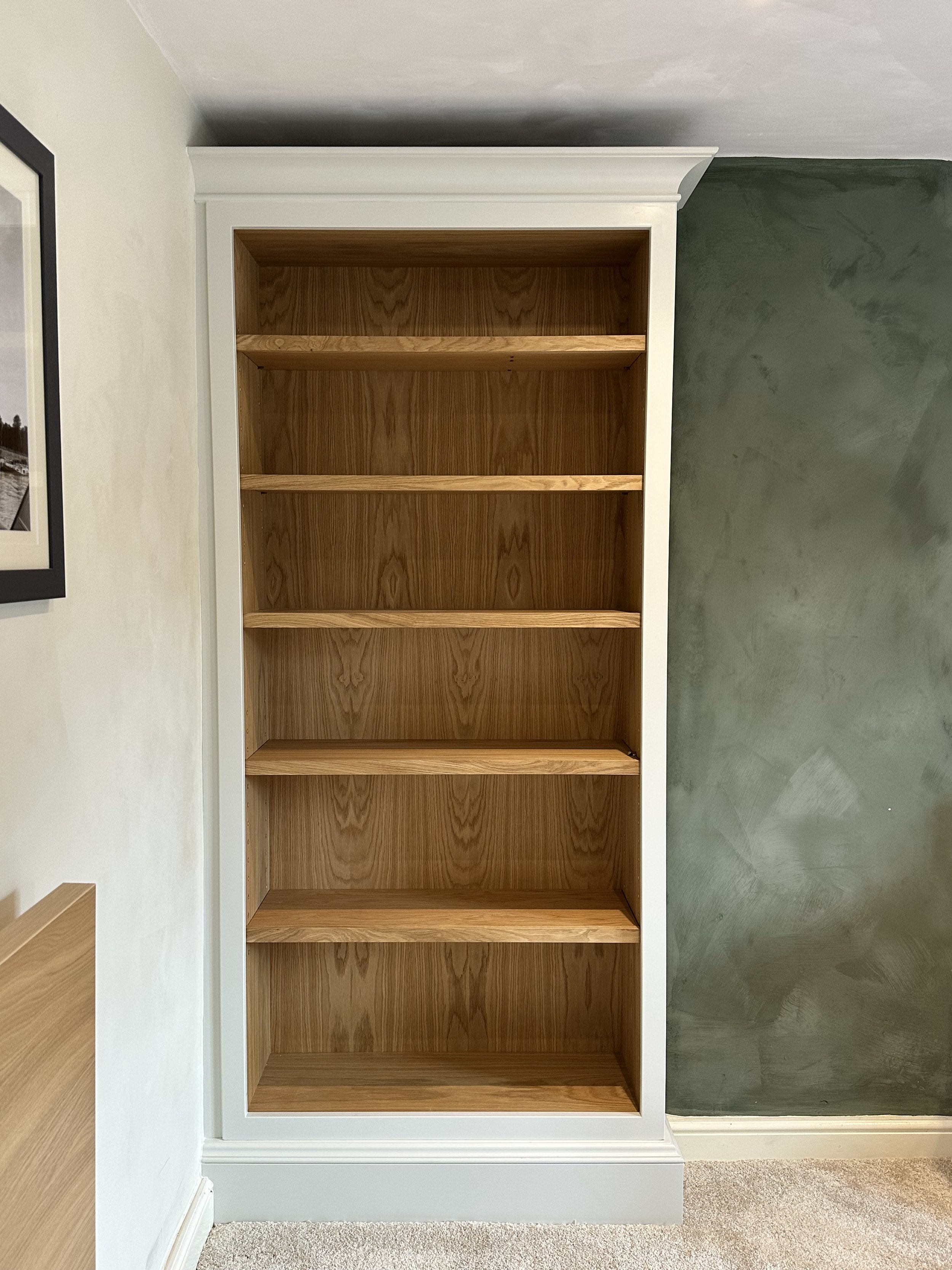 Fitted bedroom bookcase. Oiled oak interior, solid oak lipped shelves, brass socket adjustable shelf pins, Little Greene 'mirror' sprayed exterior, all bespoke mouldings
