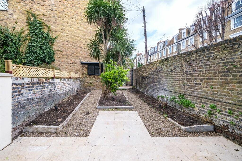 A photo of an unloved and unpractical garden before the new garden design was installed, as part of a before/after.
