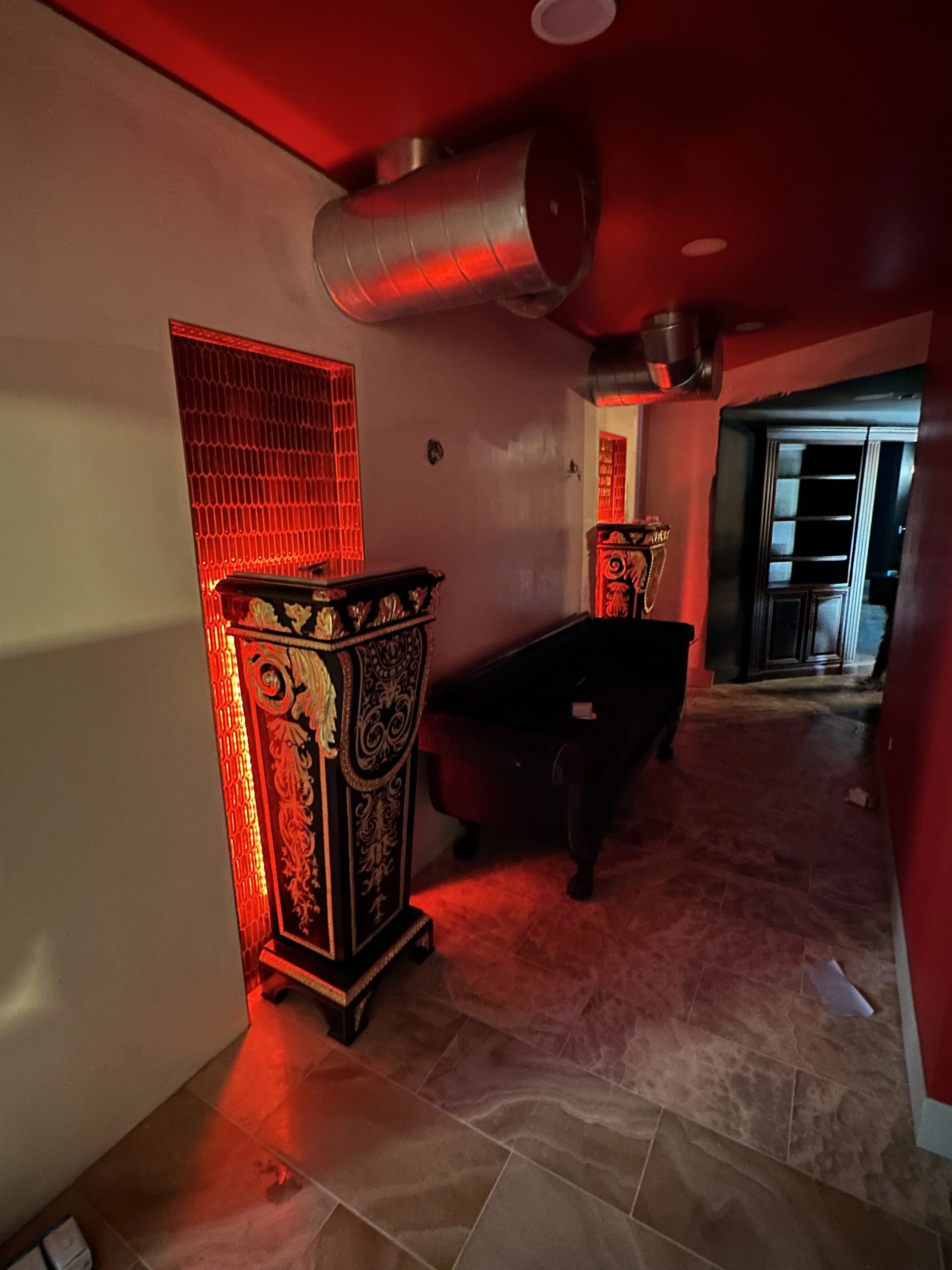 A hallway with red lighting and decorative black and gold furniture | Electrical Services | Rio Rancho, NM |