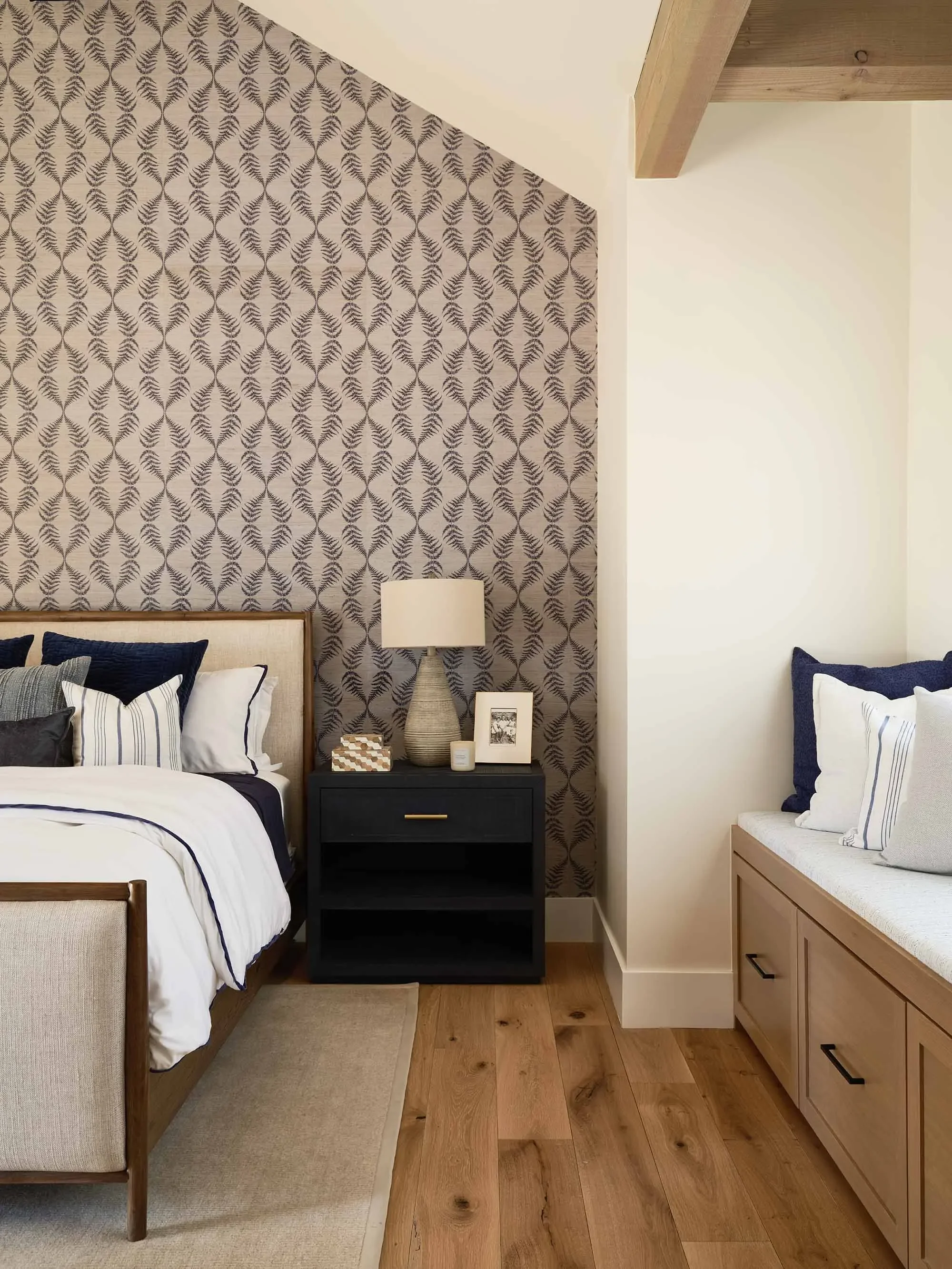Patterned botanical wallpaper and natural finishes in cozy bedroom, designed by Julie Beuerlein, interior designer