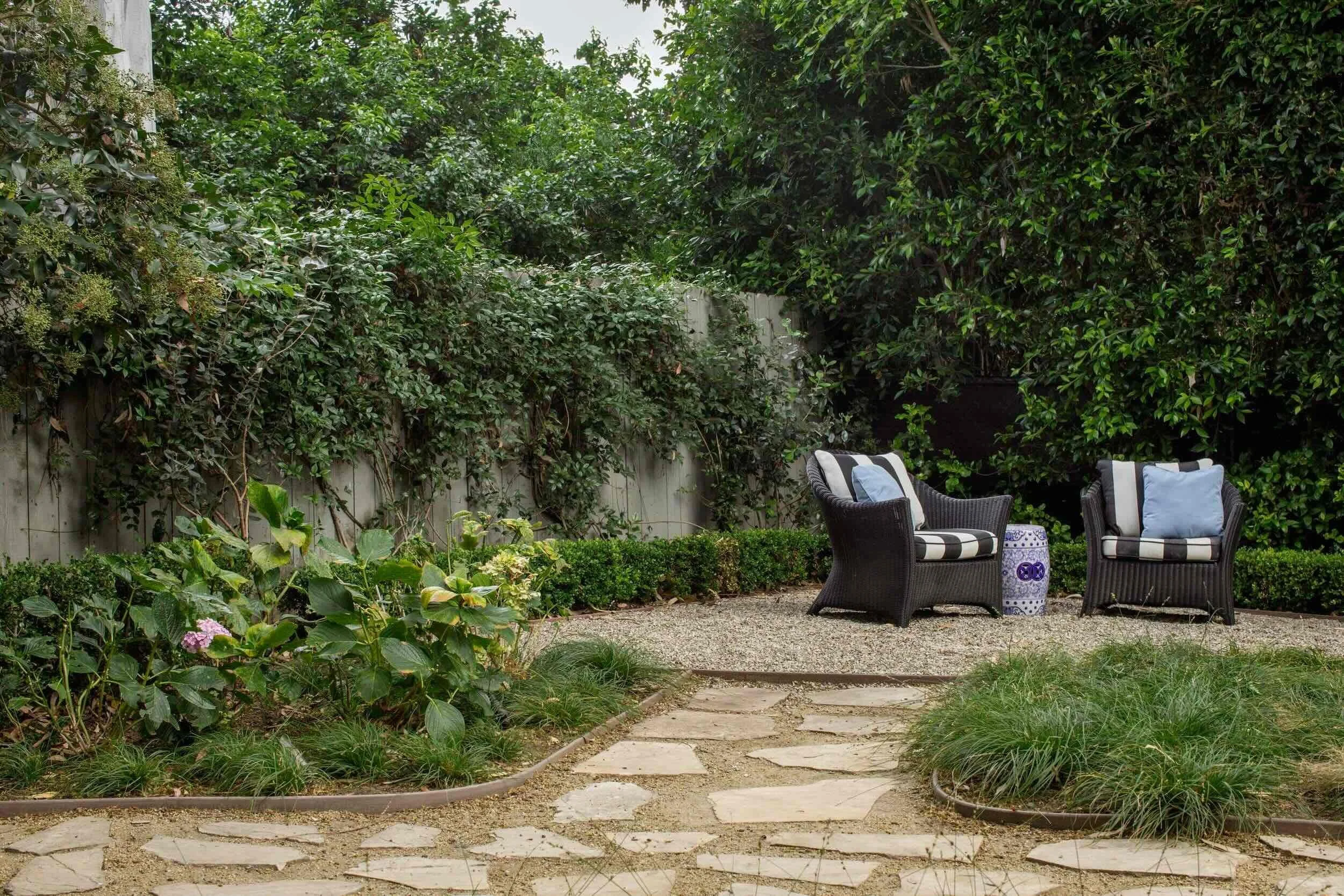 Intimate garden seating area surrounded by lush landscaping in Palos Verdes Estates, designed by JKB Home Design