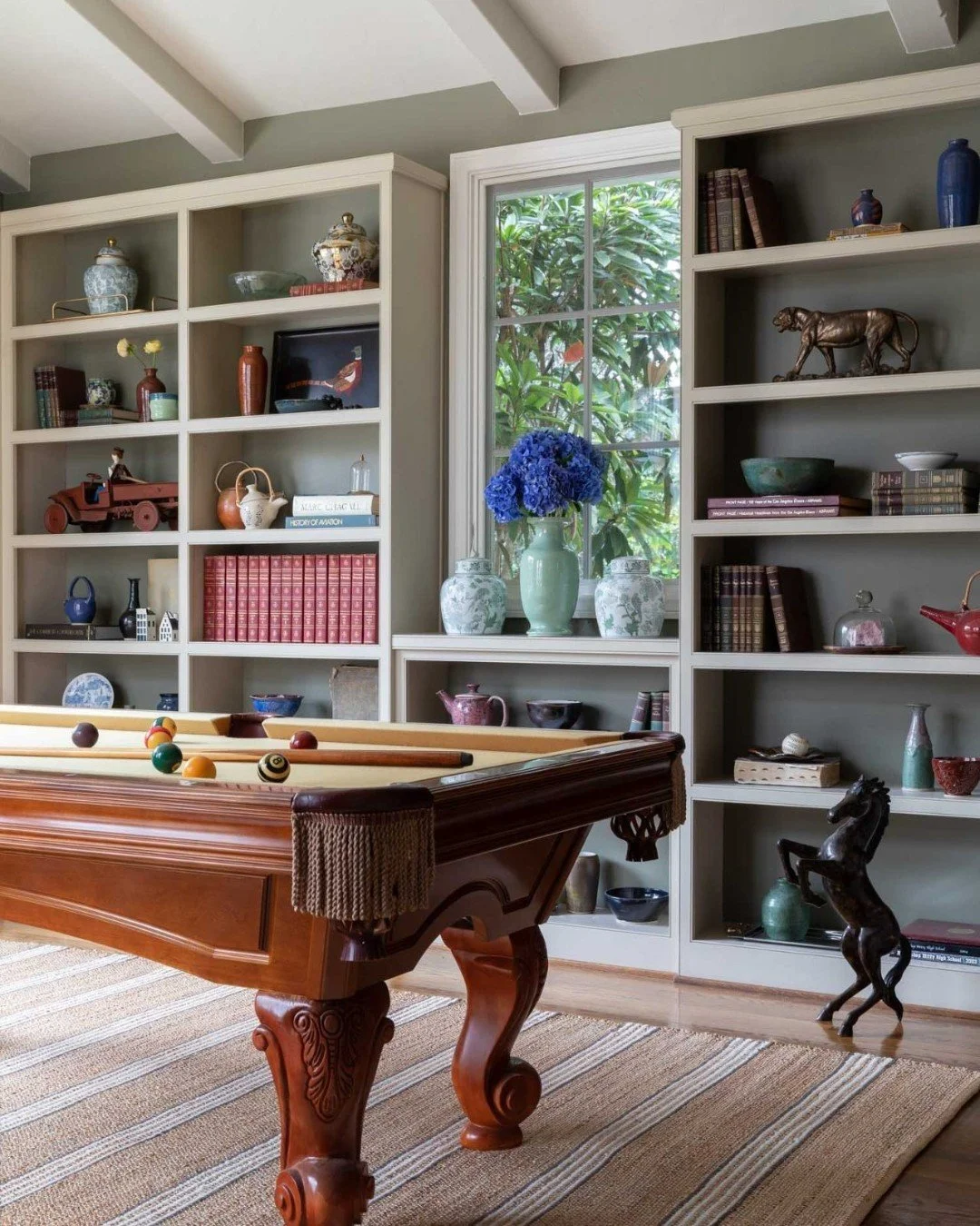 Game room, but make it elevated ✨

Designed with both style and function in mind, this space centers around a classic pool table and custom built-ins that bring structure, storage, and a sense of permanence to the room. Rich materials and tailored de
