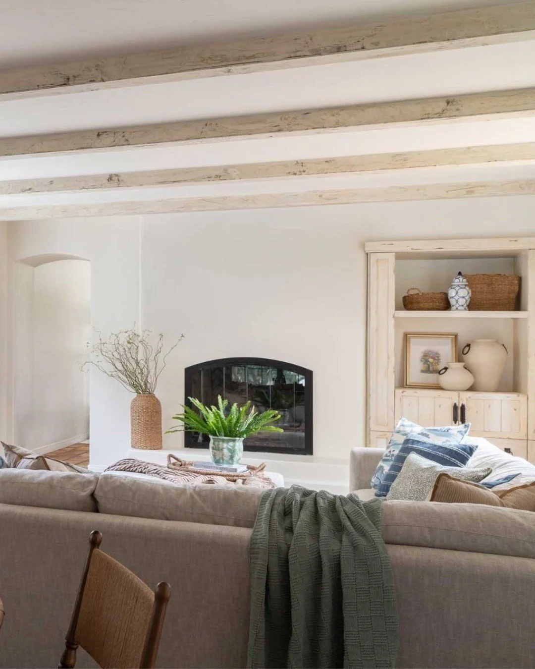 A quieter moment at The Reimagined Villa...

This living room was designed to feel more reserved&mdash;an intentional contrast to the rest of the home. Anchored by the fireplace and layered with family vintage pieces, the space leans into a sense of 