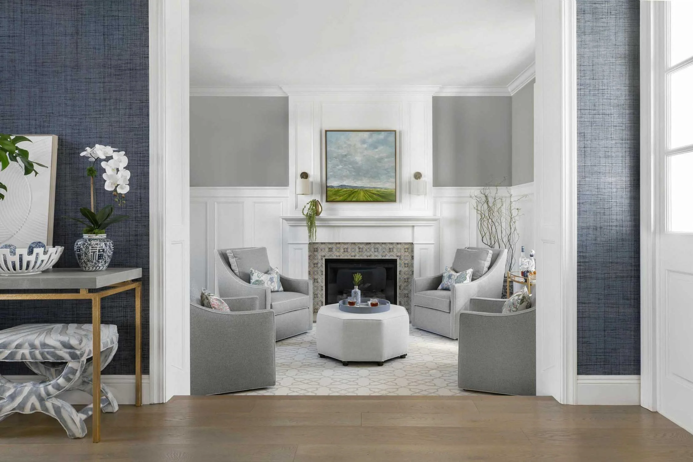 Elegant parlor with classic layout and grey armchairs, designed by JKB Home Design in Pacific Palisades