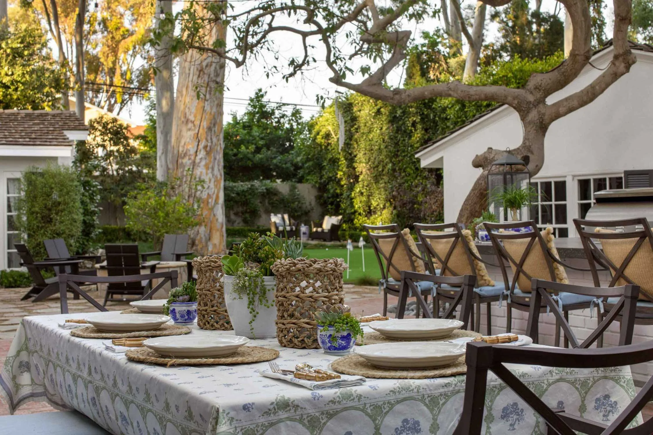 Backyard dining area with bistro lights at Palos Verdes ranch home – JKB Home Design