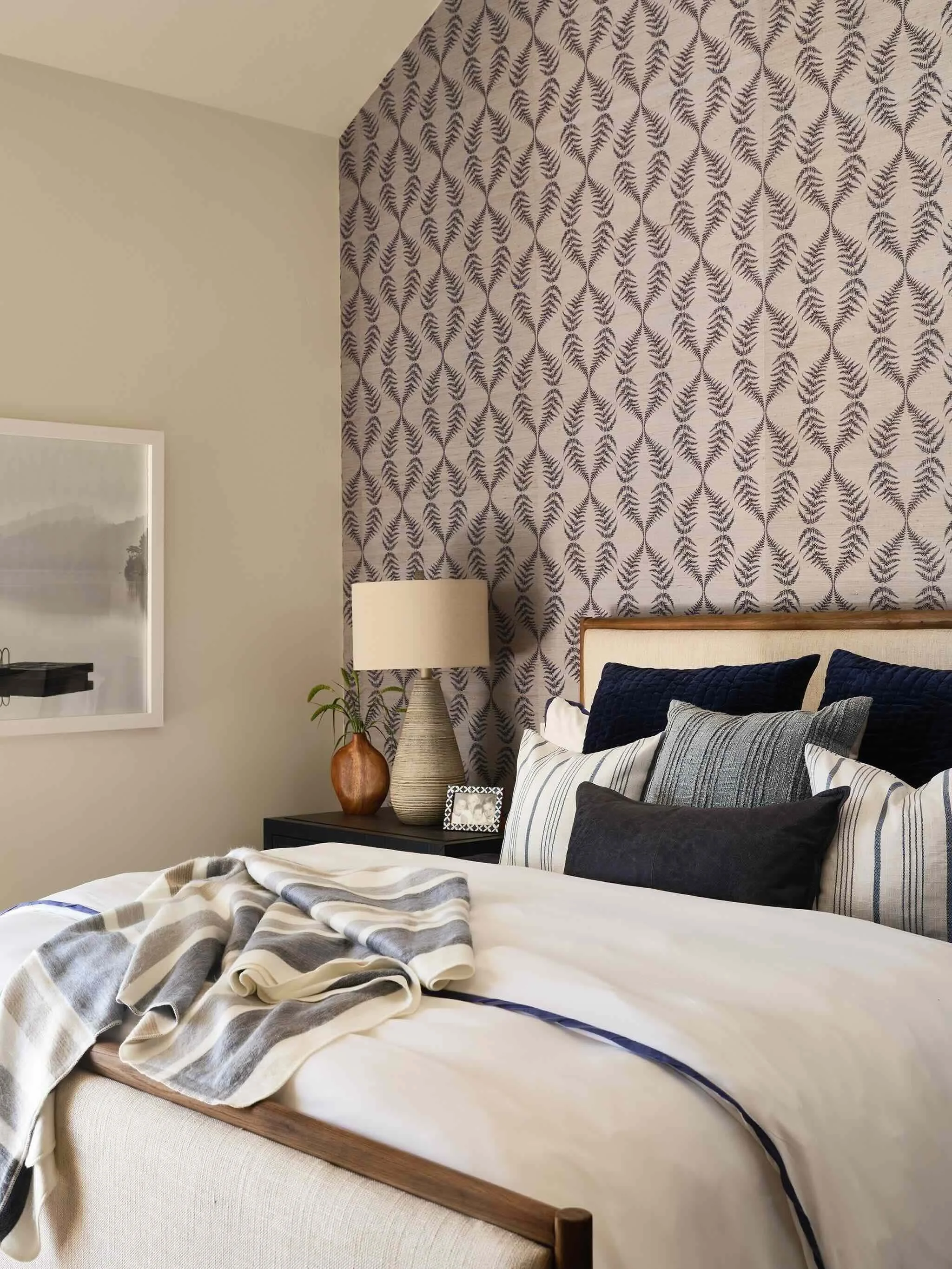 Clear Creek Tahoe guest bedroom with patterned wallpaper, blue and gray bedding, and bay window reading nook by JKB Home Design