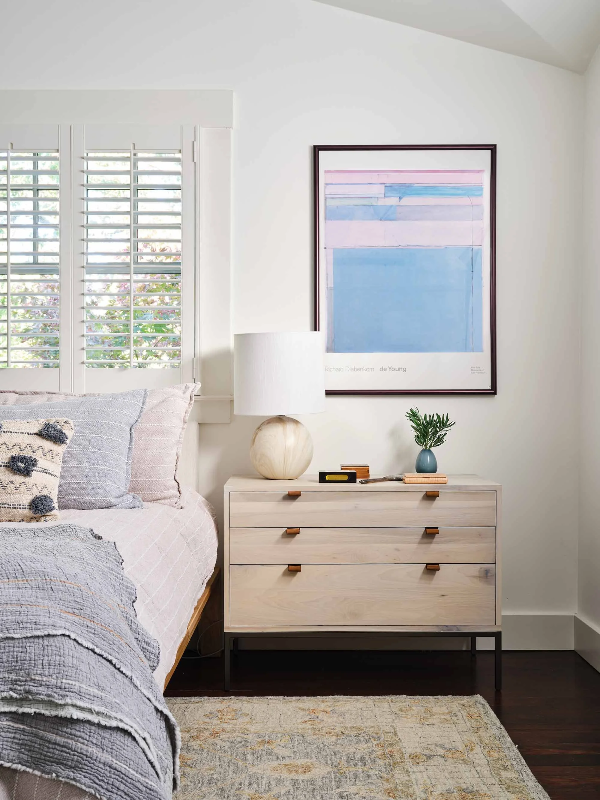Bedroom with blue wall art and pale wood dresser, designed by Julie Beuerlein, interior designer, San Anselmo