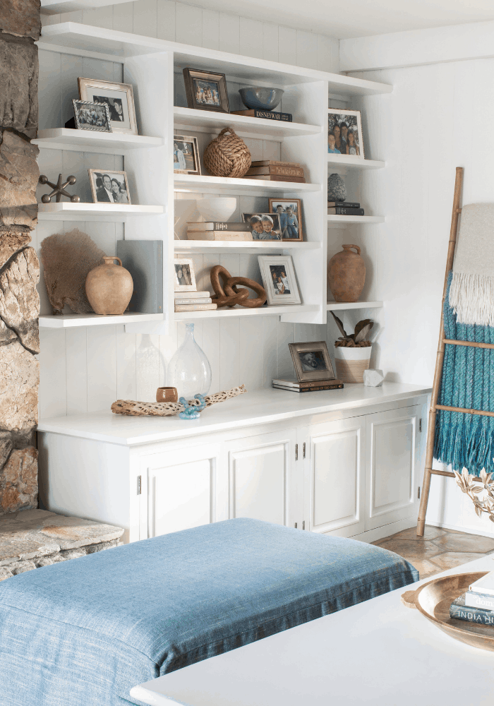 White built-in shelves styled with family photos, books, pottery, and collected decor in Palos Verdes Estates