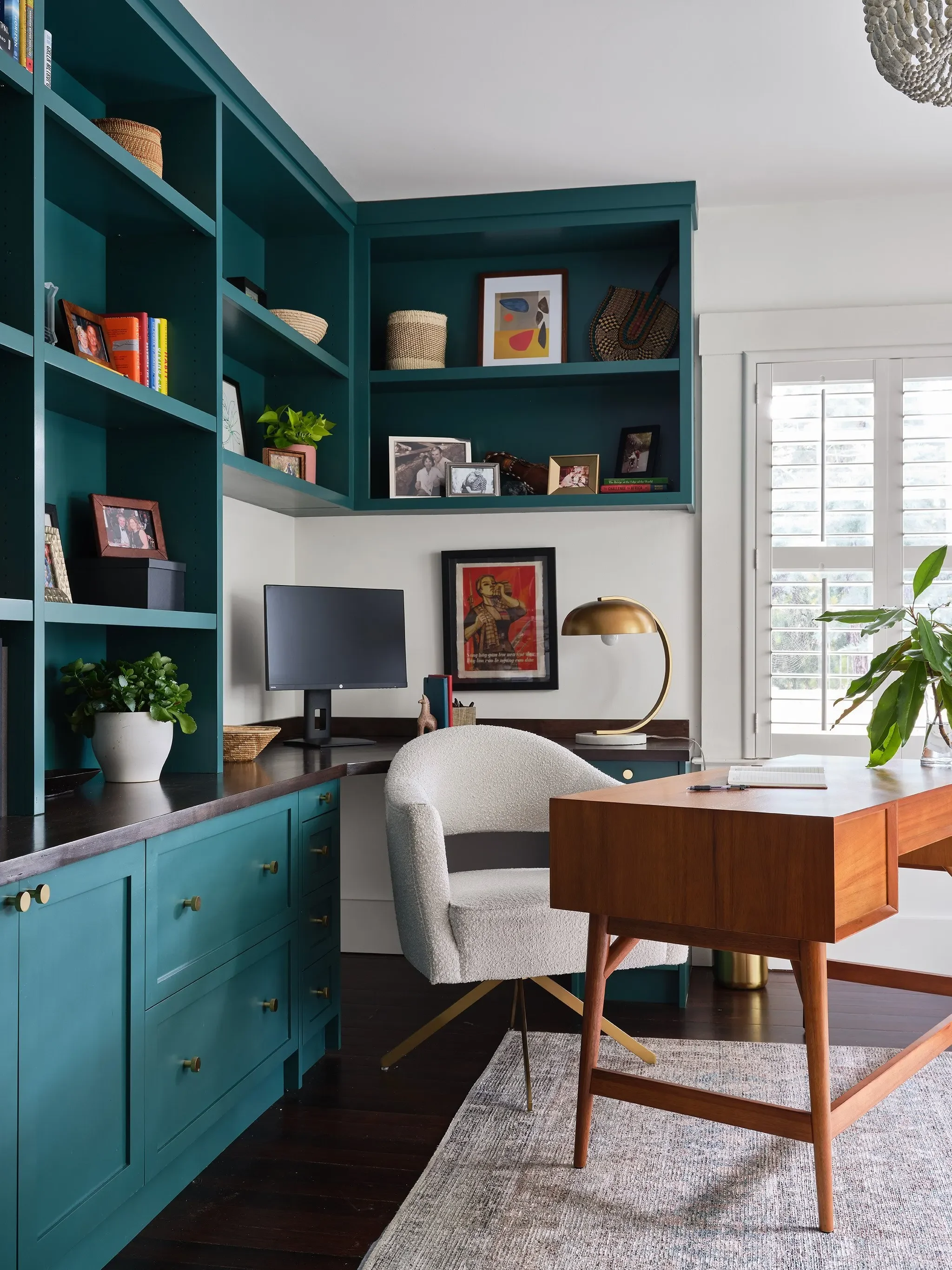 Eclectic San Anselmo home office with teal built-in cabinetry, mid-century wood desk, and boucle chair by JKB Home Design
