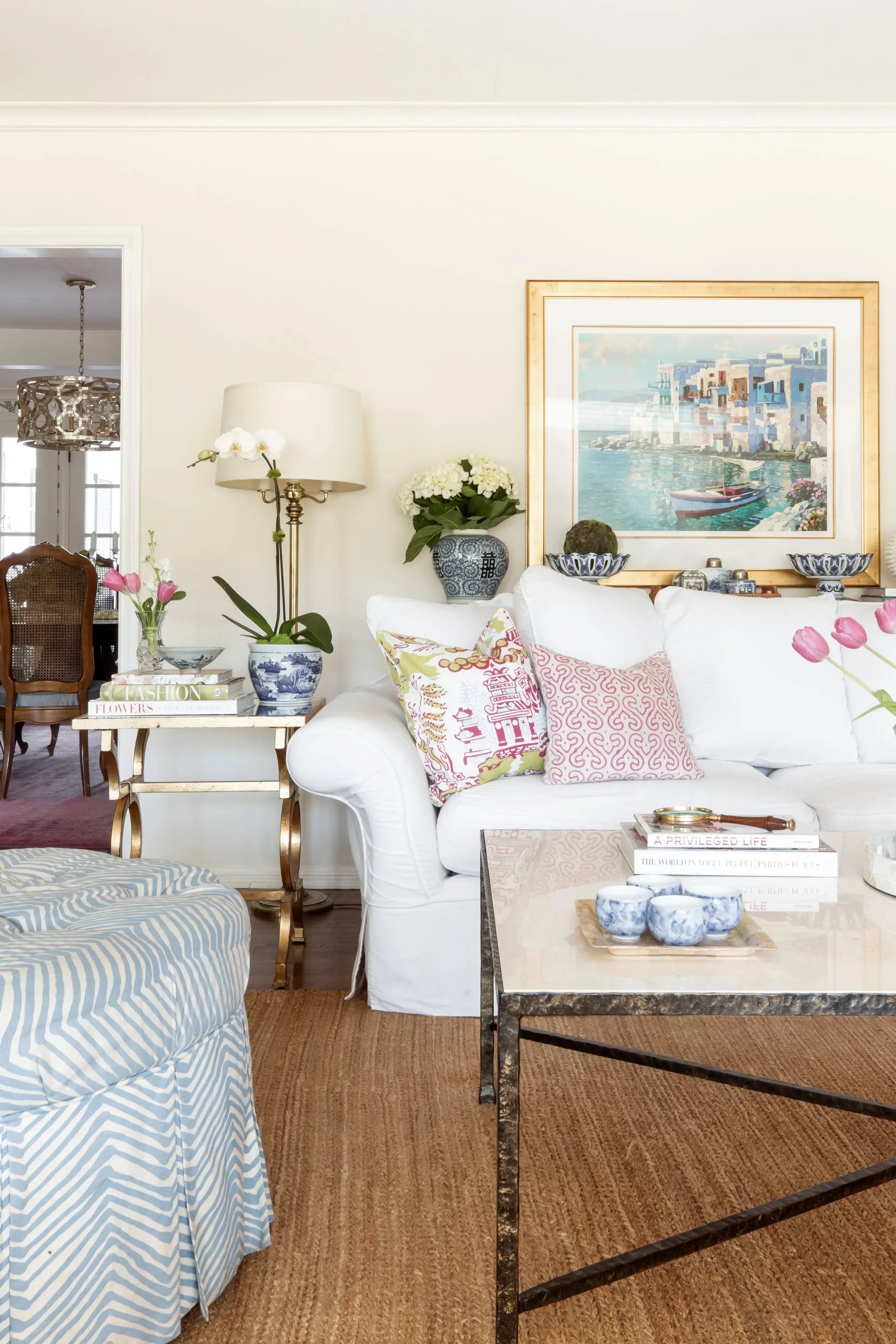 Colorful Palos Verdes Estates living room with white sofa, patterned pillows, blue and white ceramics, and layered decor by JKB Home Design