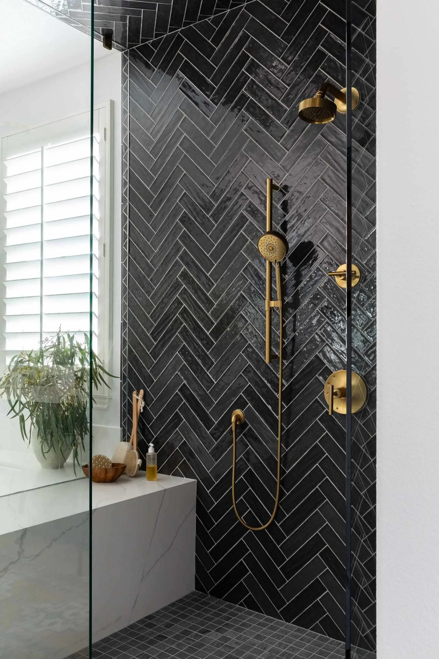 Primary bathroom with charcoal herringbone tile shower, designed by JKB Home Design in Aliso Viejo