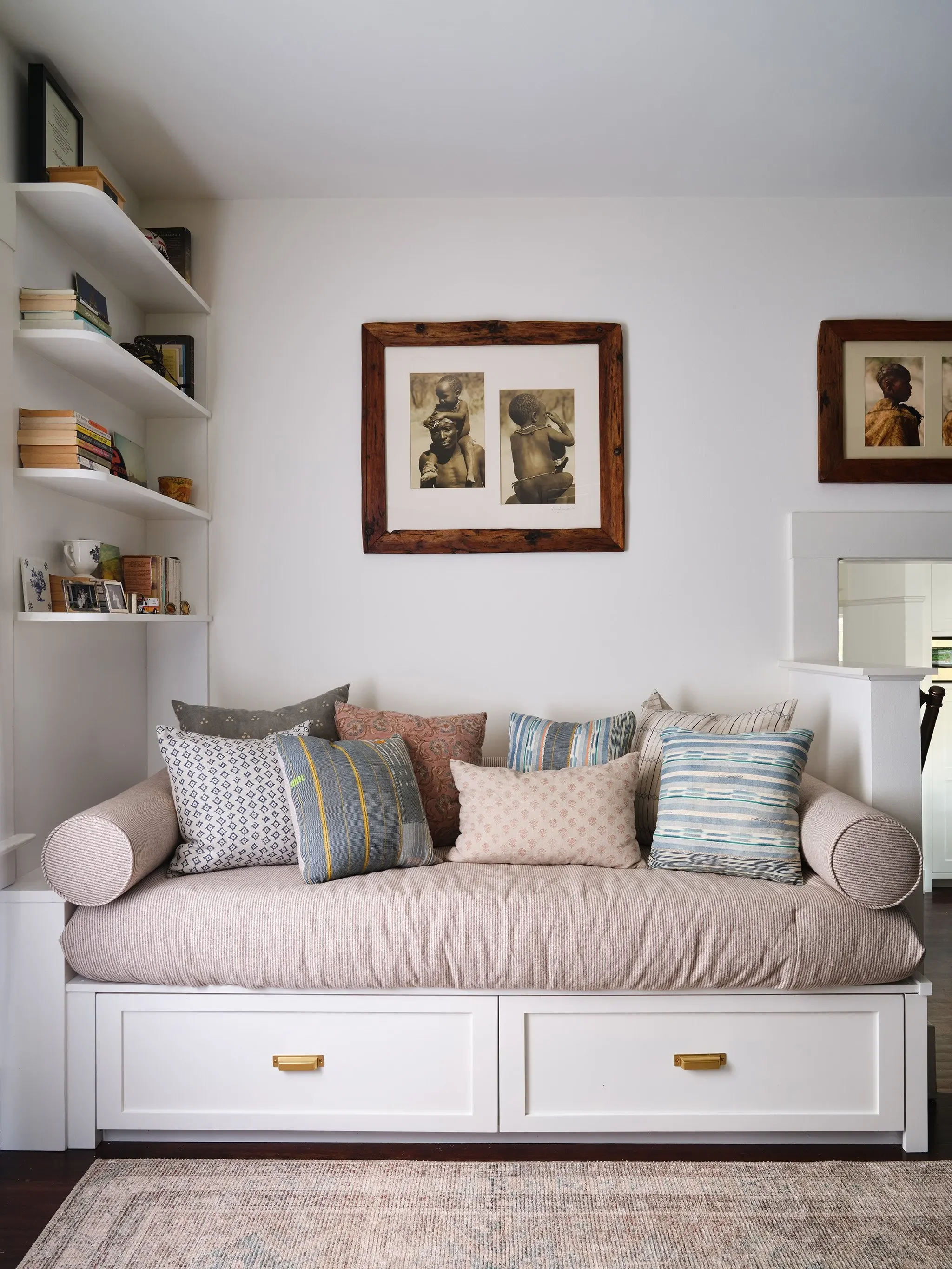 Built-in San Anselmo daybed with colorful custom pillows and meaningful artwork, designed by Julie Beuerlein