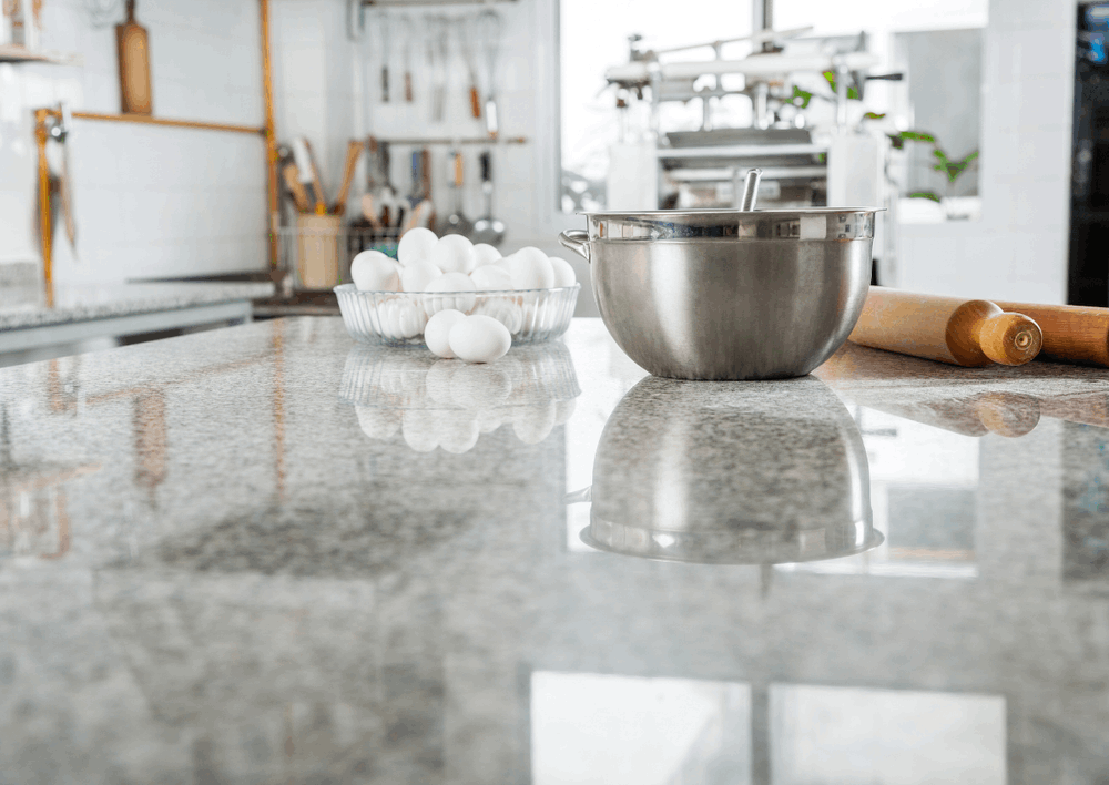 Kitchen countertop with mixing bowl, eggs, and rolling pin illustrating a durable surface for everyday family life