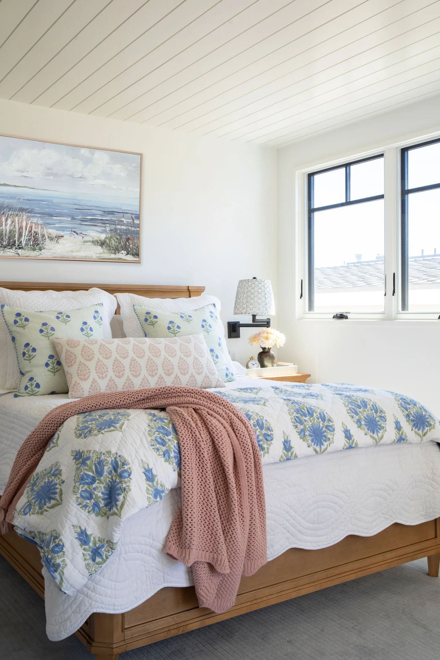 Coastal bedroom with blue floral bedding and soft pink accents in Manhattan Beach, designed by JKB Home Design