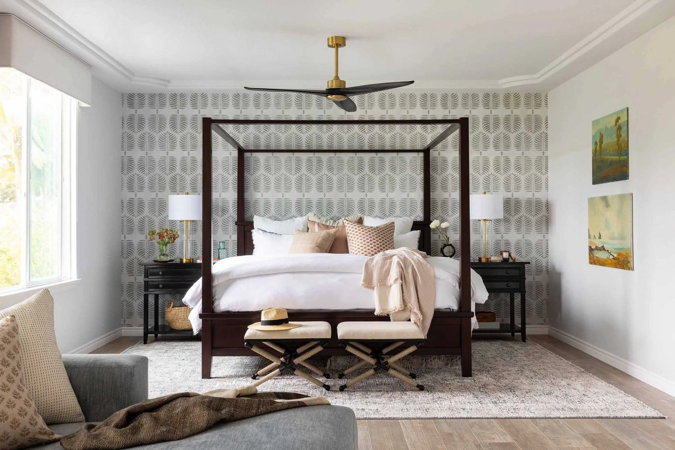 Dark wood bed frame with botanical wallpaper in Aliso Viejo primary suite, designed by Julie Beuerlein, interior designer