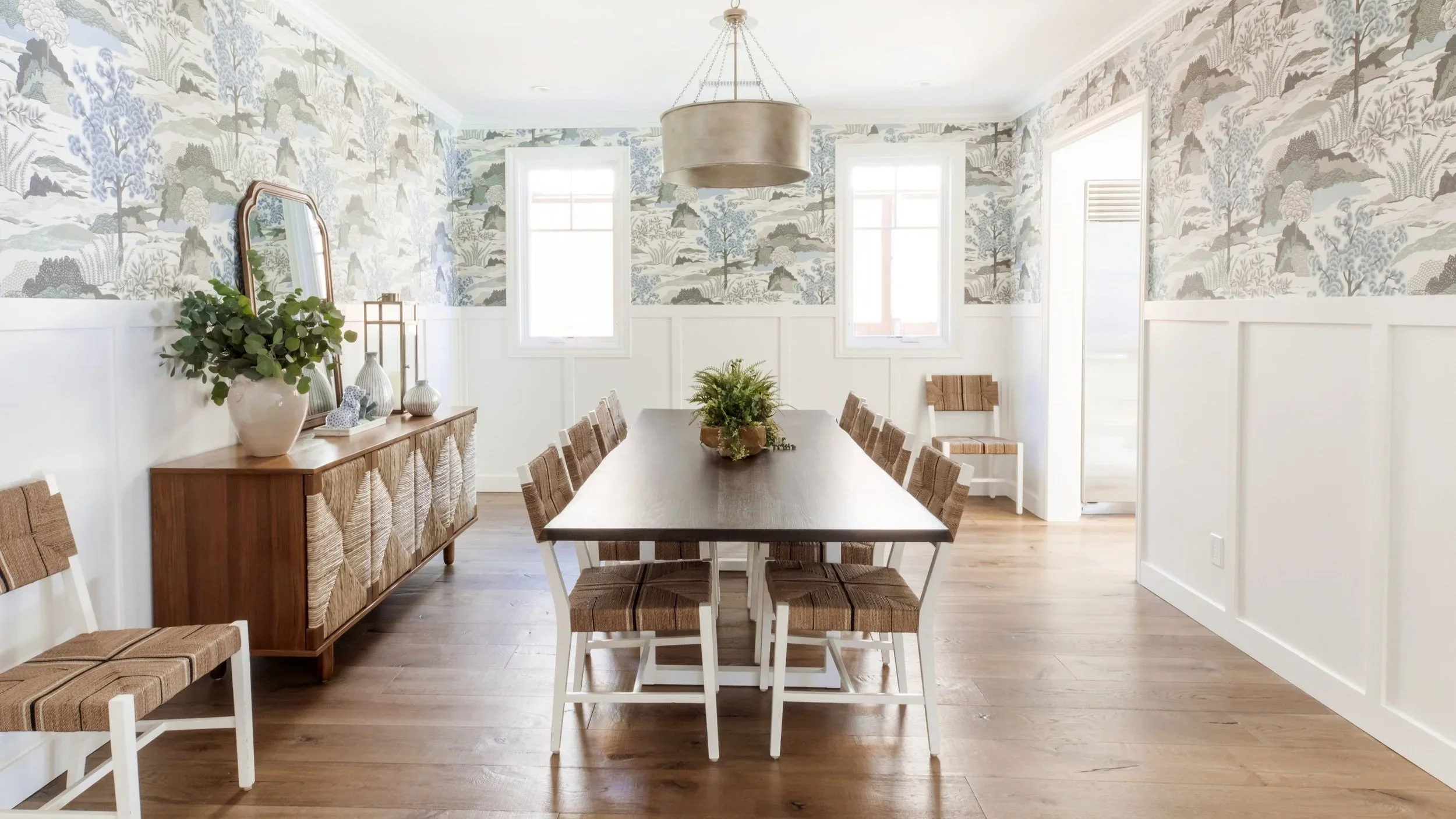 Whimsical dining room with gold pendant and rattan seating, designed by JKB Home Design